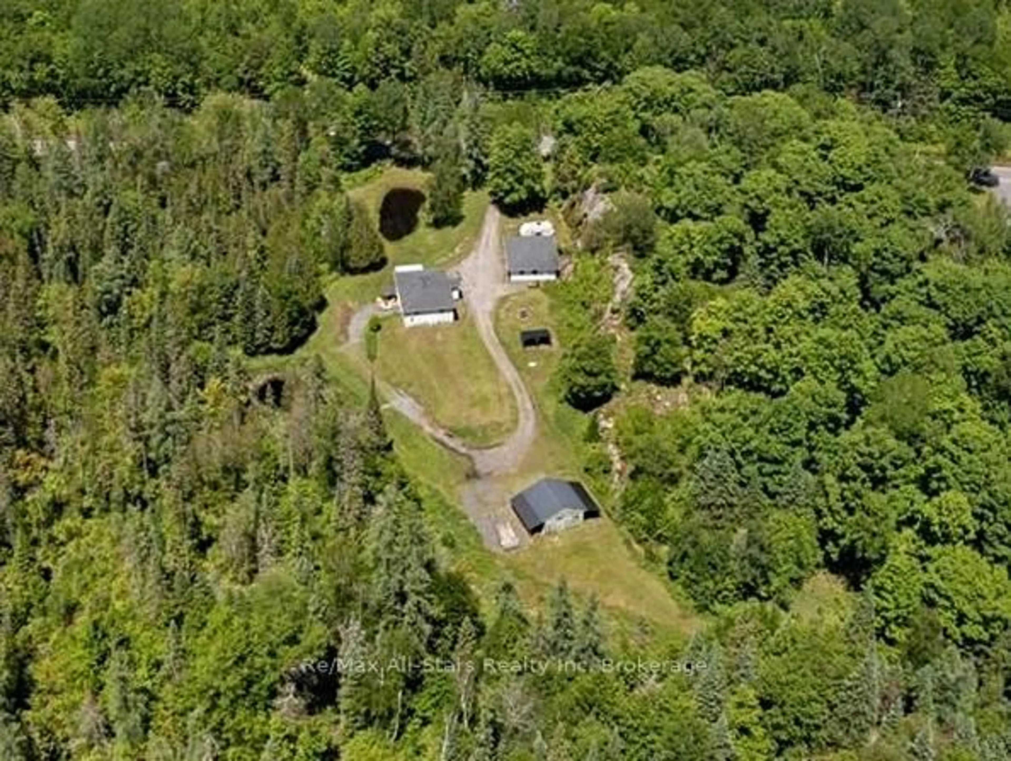 A pic from outside/outdoor area/front of a property/back of a property/a pic from drone, forest/trees view for 410 Etwell Rd, Huntsville Ontario P1H 2J2