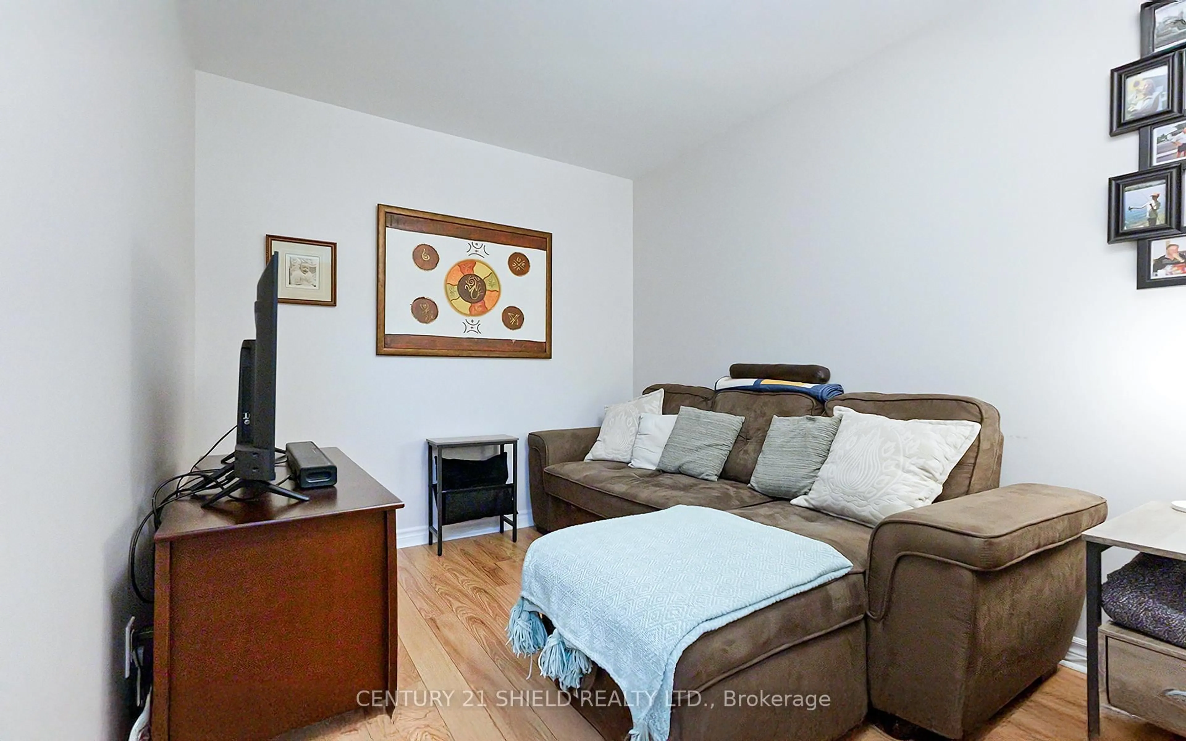 Living room with furniture, wood/laminate floor for 710 Cotton Mill St #510, Cornwall Ontario K6H 7L3
