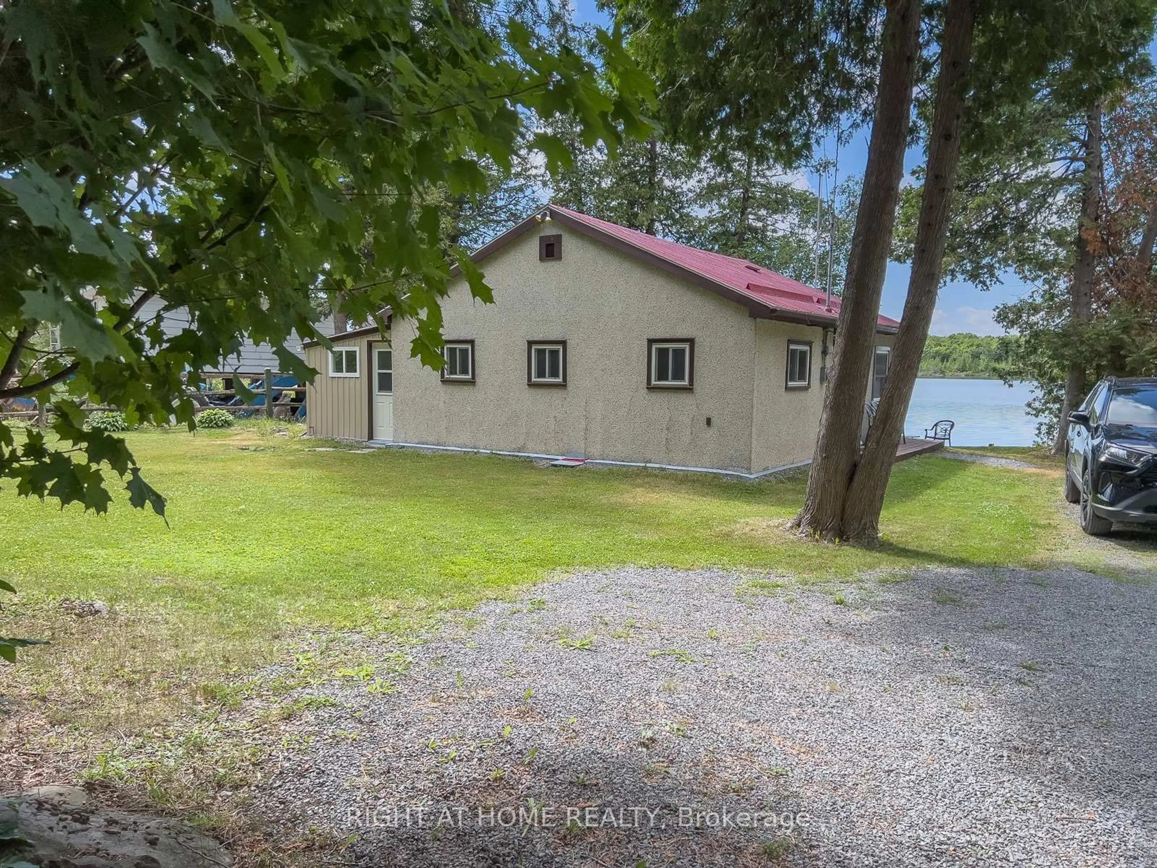 A pic from outside/outdoor area/front of a property/back of a property/a pic from drone, water/lake/river/ocean view for 58 Cottage Lane, Greater Napanee Ontario K0K 2L0