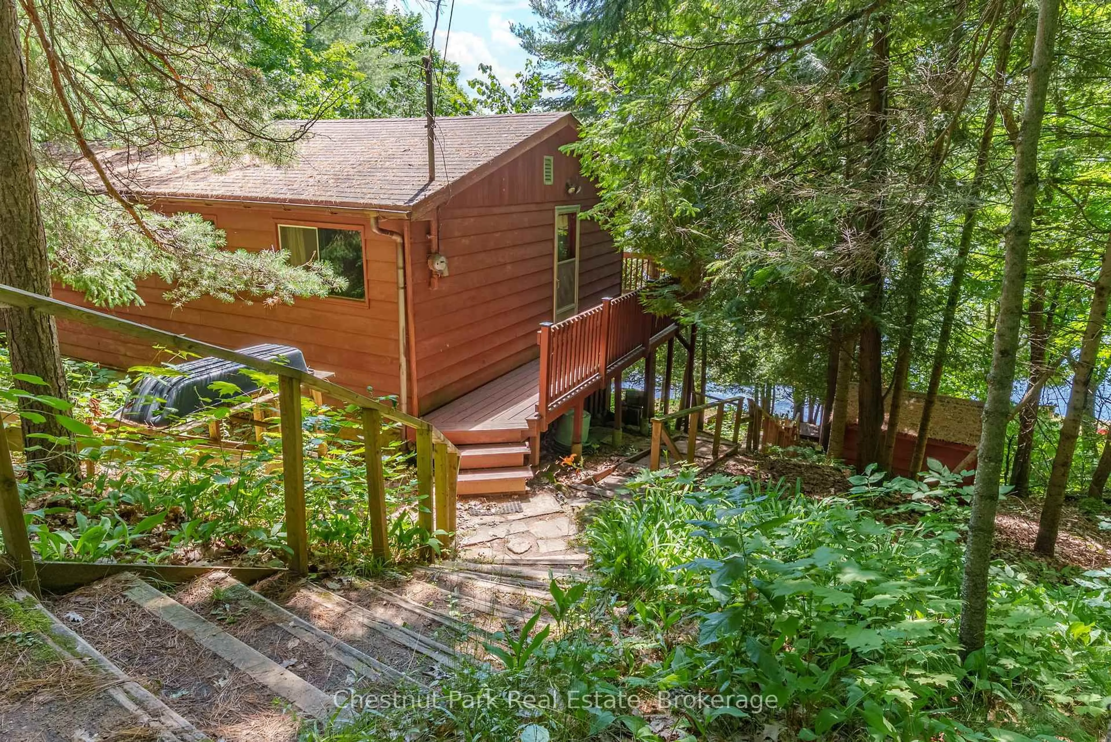 A pic from outside/outdoor area/front of a property/back of a property/a pic from drone, forest/trees view for 1054 10 Deewood Dr, Muskoka Lakes Ontario P0B 1M0