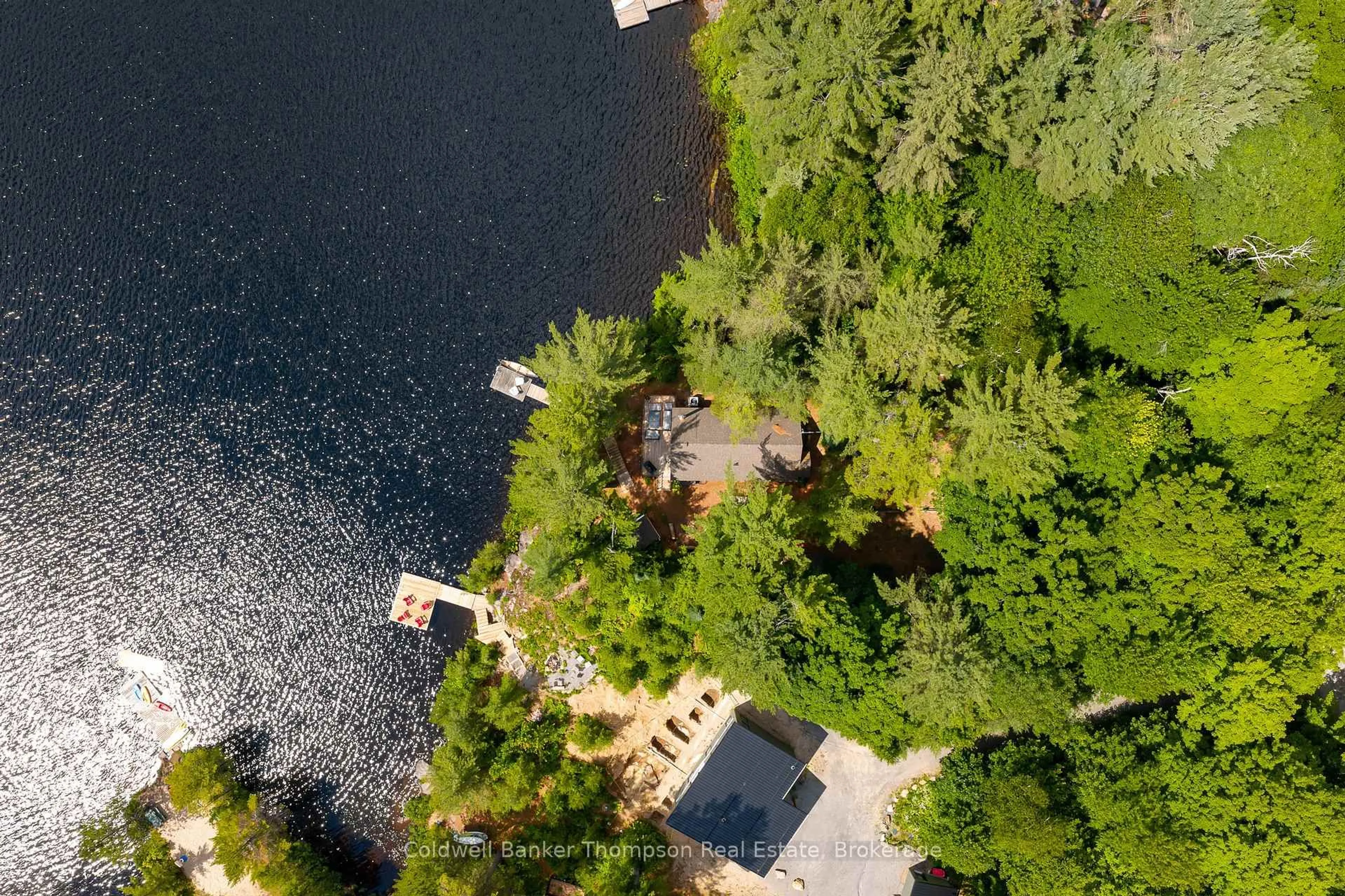 A pic from outside/outdoor area/front of a property/back of a property/a pic from drone, water/lake/river/ocean view for 210 Otter Lake Cottage Rd, Huntsville Ontario P1H 2J3
