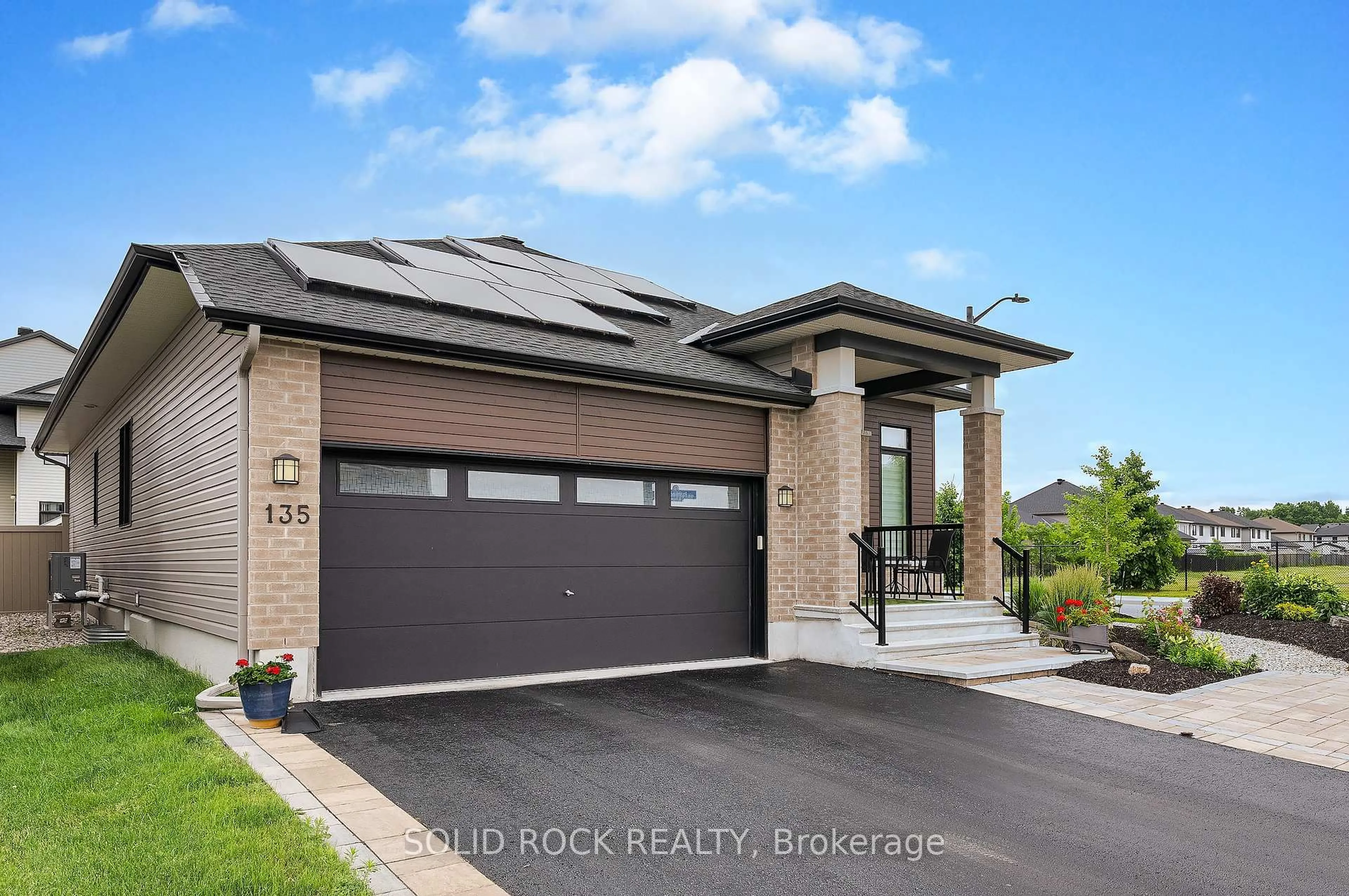 Home with brick exterior material, street for 135 Pathfinder Way, Ottawa Ontario K1X 0C9