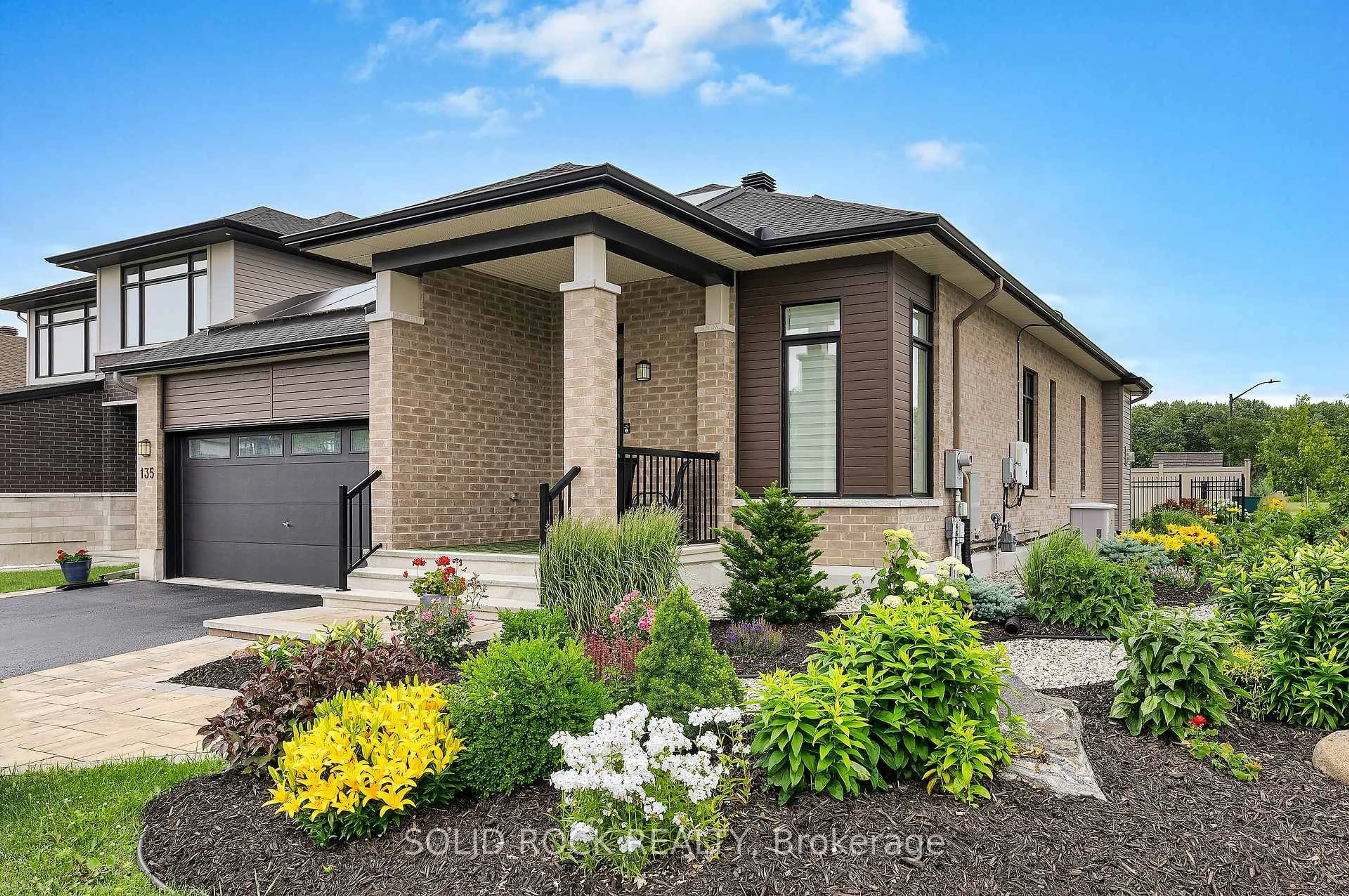 Home with brick exterior material, street for 135 Pathfinder Way, Ottawa Ontario K1X 0C9