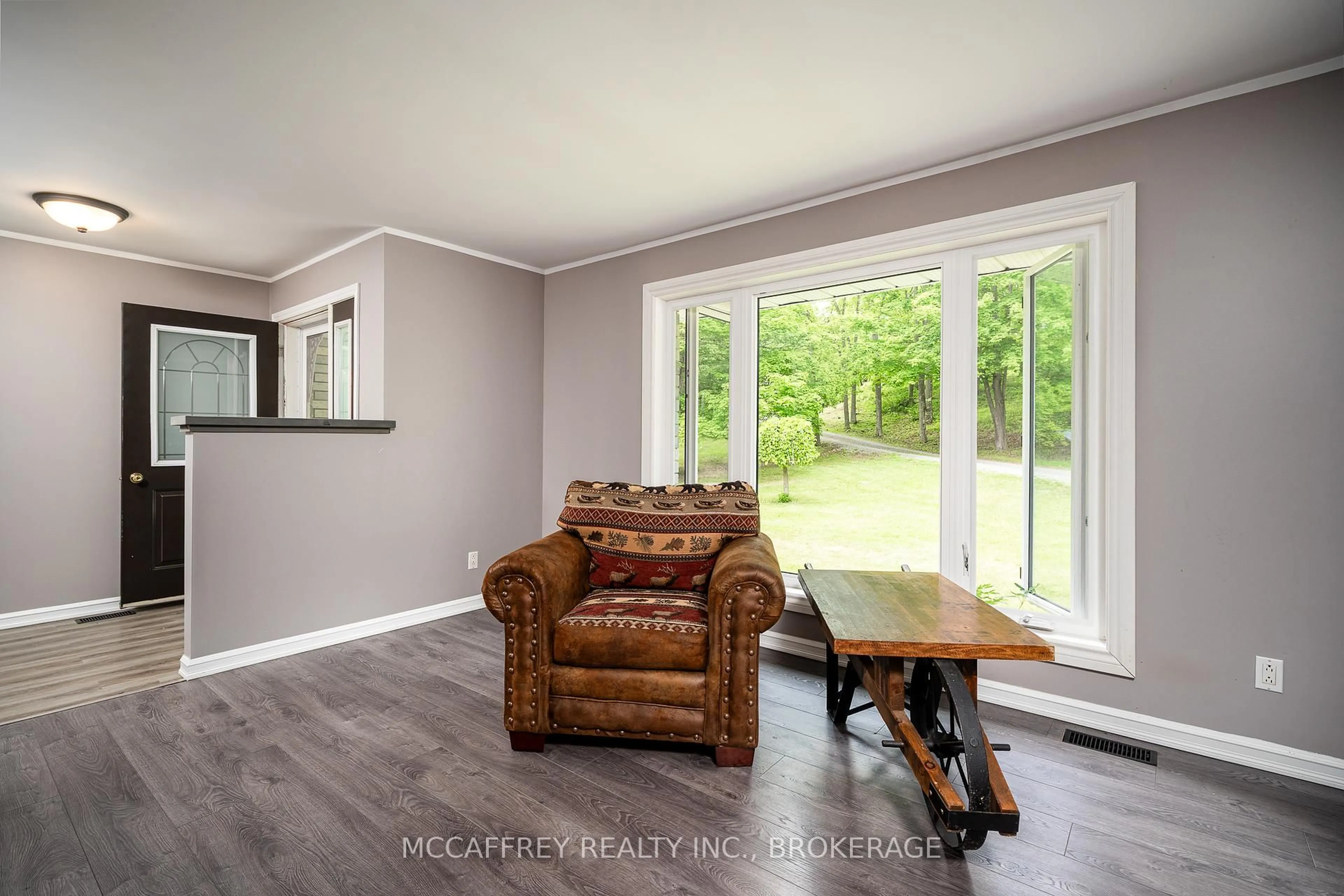 Living room with furniture, wood/laminate floor for 51 Luffman Rd, Tweed Ontario K0K 2L0