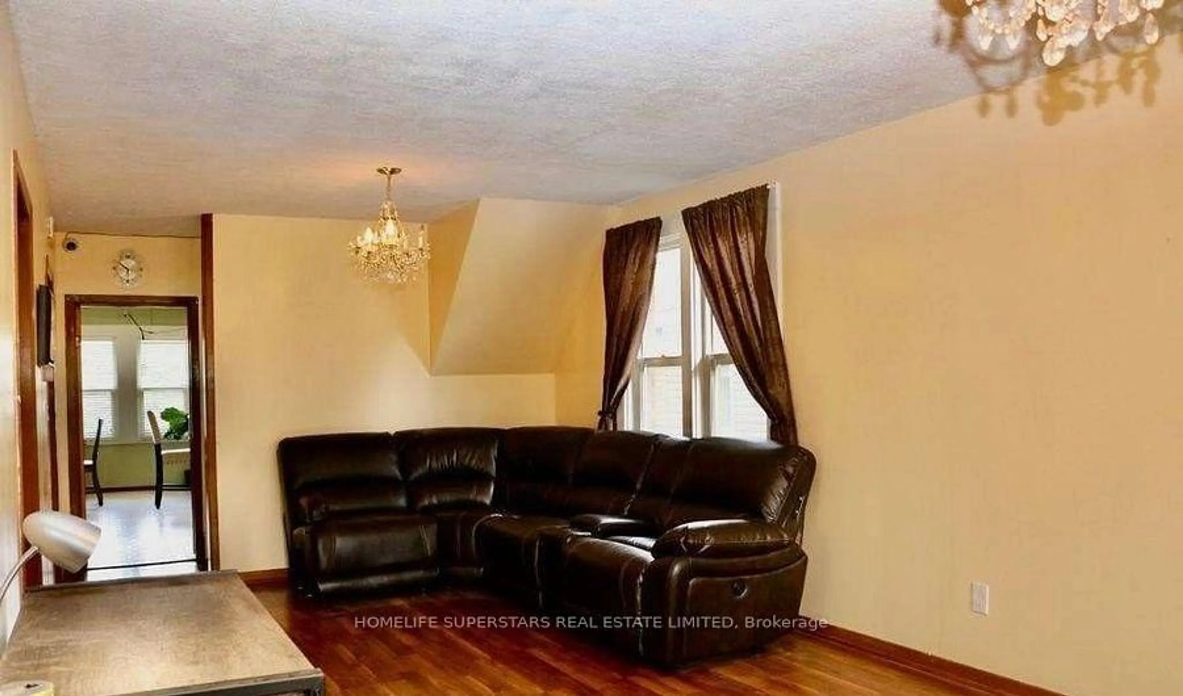 Living room with furniture, wood/laminate floor for 5991 Culp St, Niagara Falls Ontario L2G 2B6