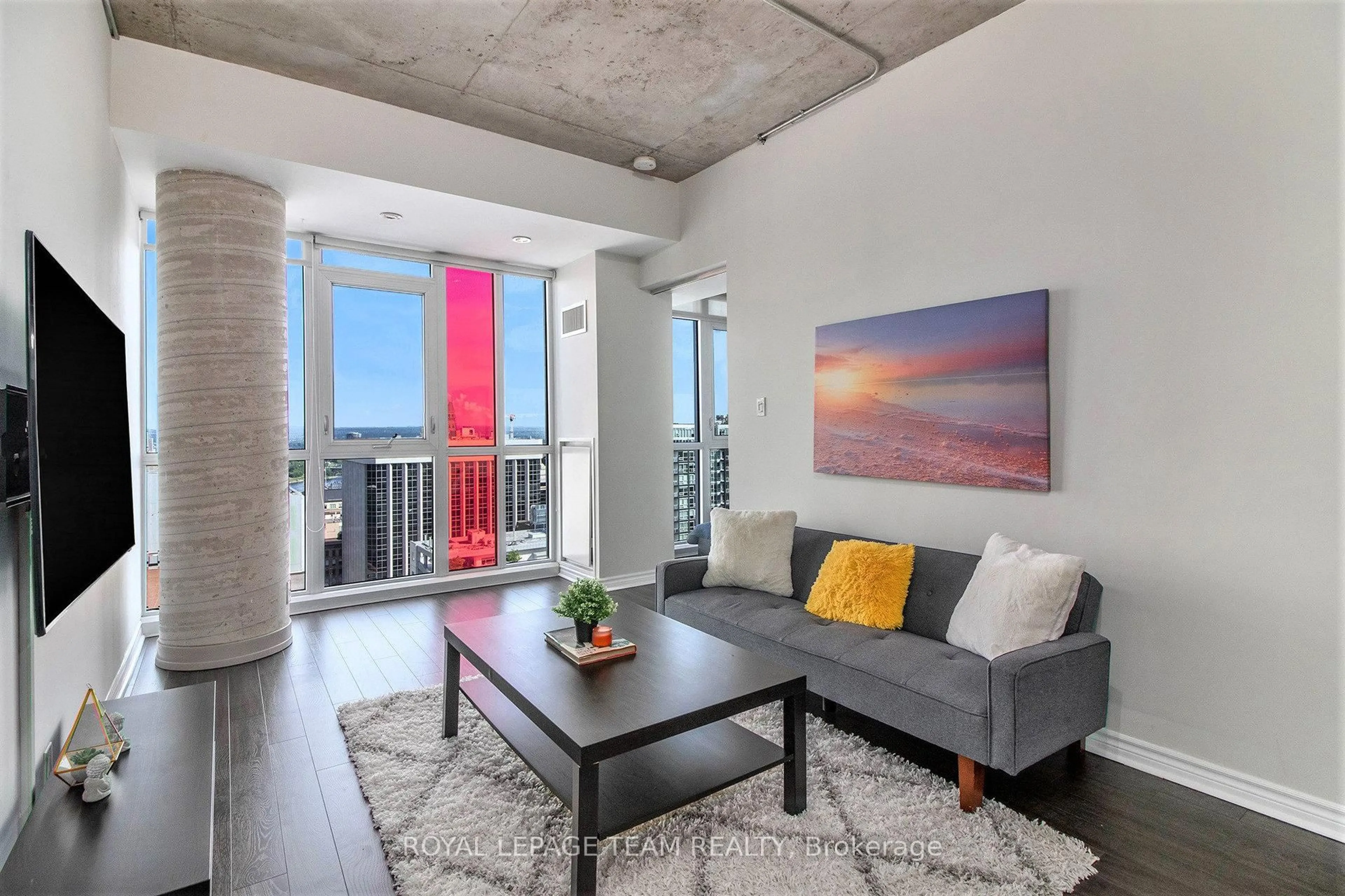 Living room with furniture, cement floor for 324 Laurier Ave #2208, Ottawa Ontario K1N 6P6