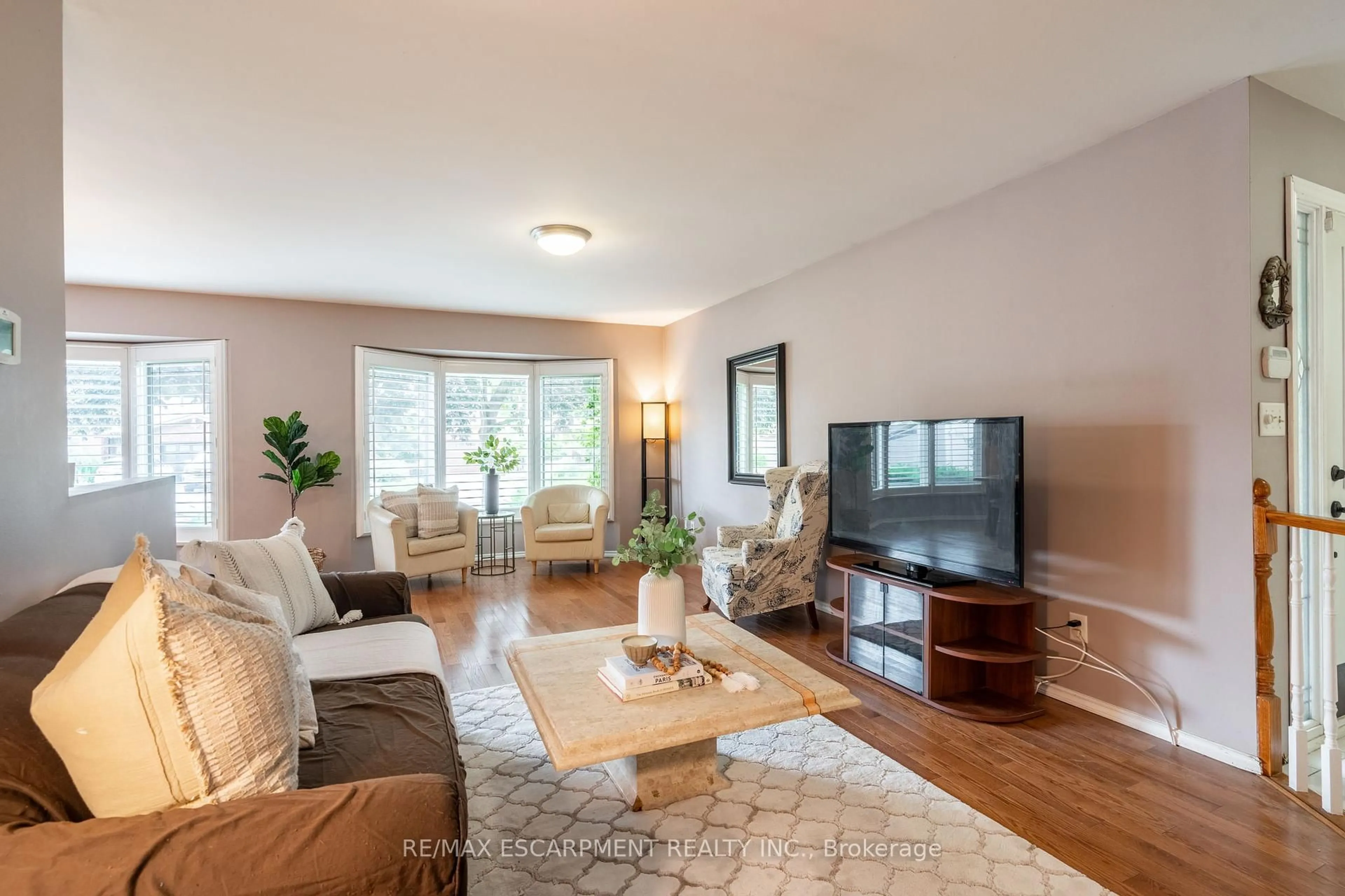 Living room with furniture, wood/laminate floor for 16 Flamingo Dr, Hamilton Ontario L9A 4X7