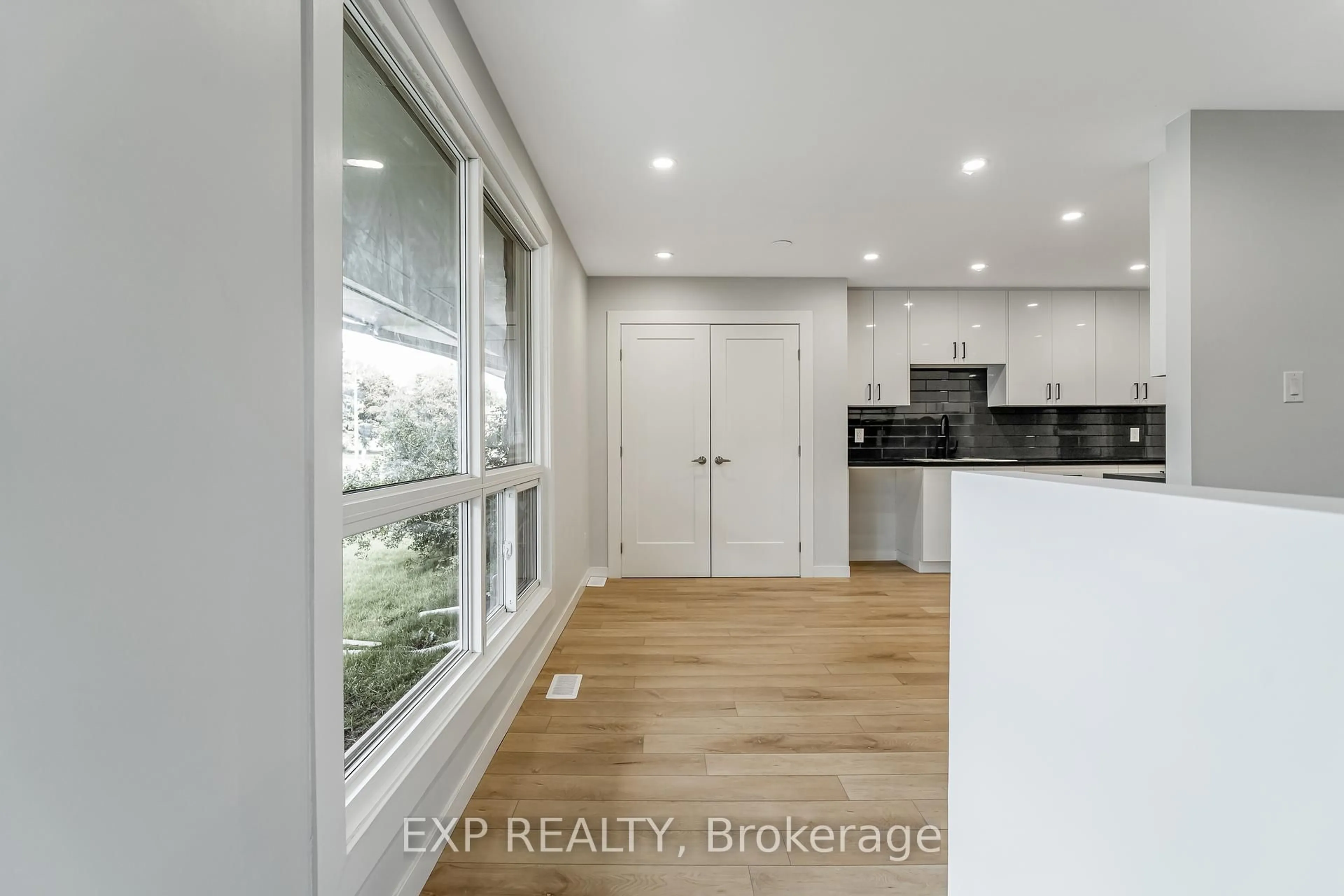 Open concept kitchen, wood/laminate floor for 110 Fieldrow St, Ottawa Ontario K2G 2Y9