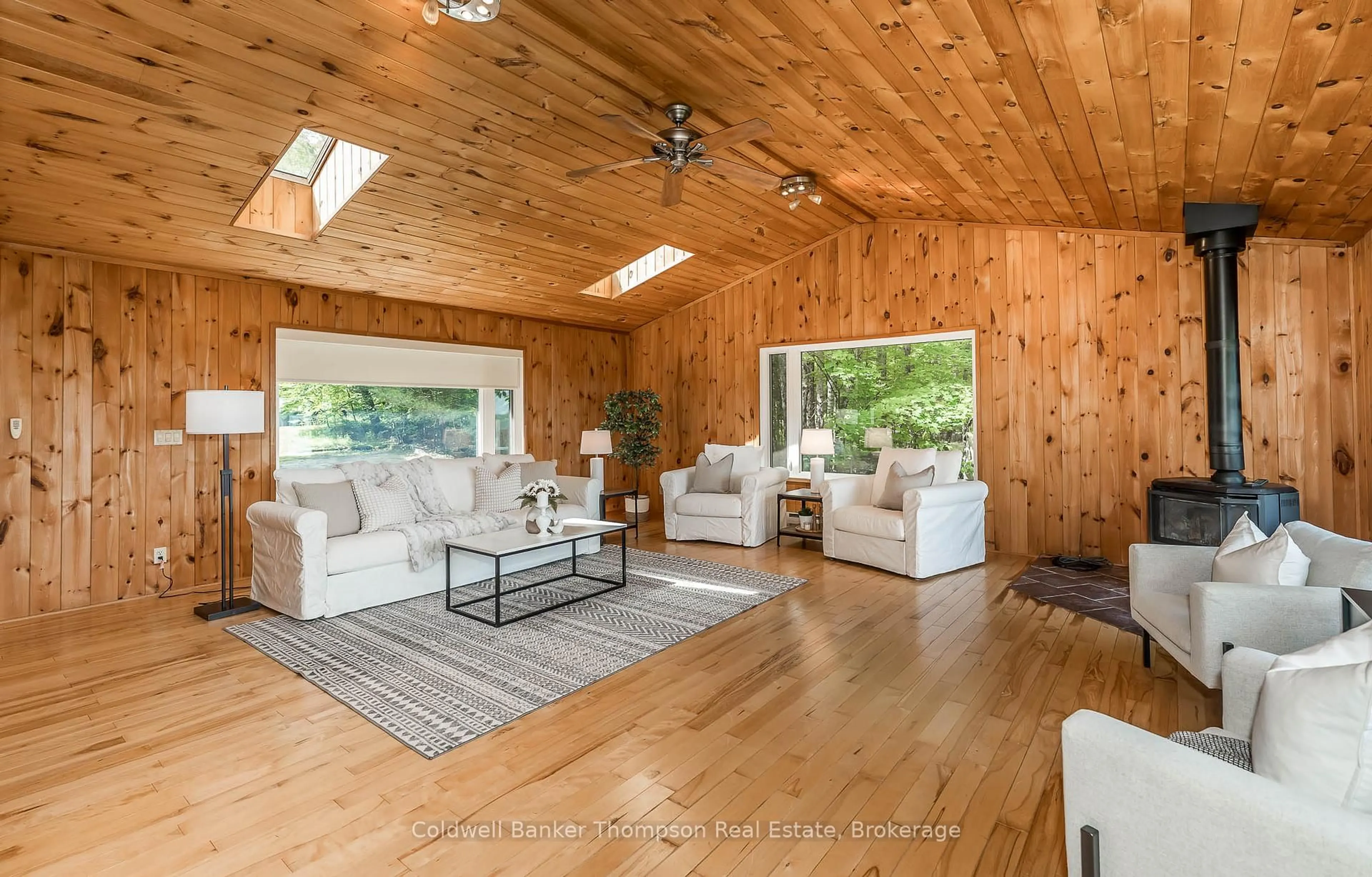 Living room with furniture, wood/laminate floor for 1090 Muskoka #10 Rd, Huntsville Ontario P0B 1L0