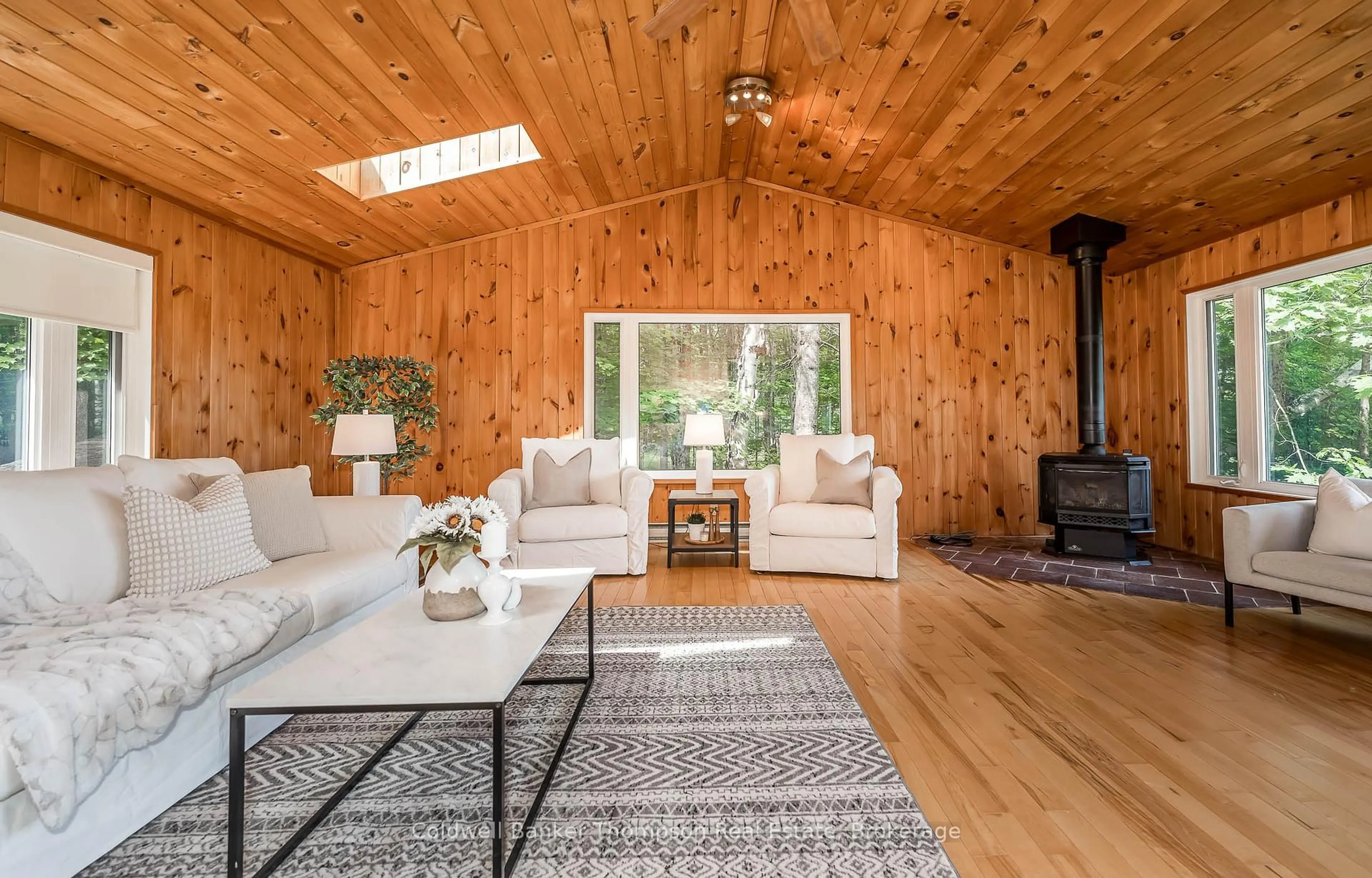 Living room with furniture, wood/laminate floor for 1090 Muskoka #10 Rd, Huntsville Ontario P0B 1L0