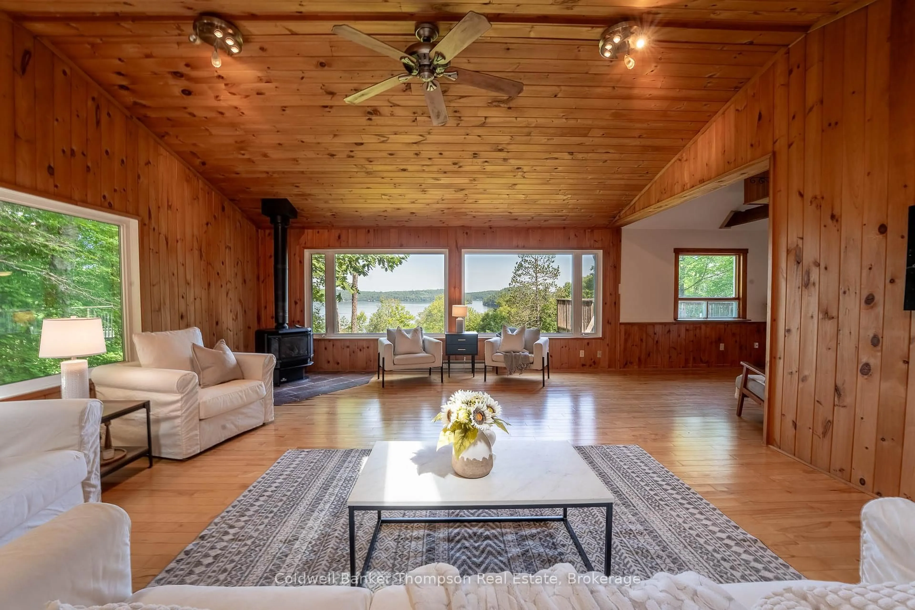 Living room with furniture, wood/laminate floor for 1090 Muskoka #10 Rd, Huntsville Ontario P0B 1L0