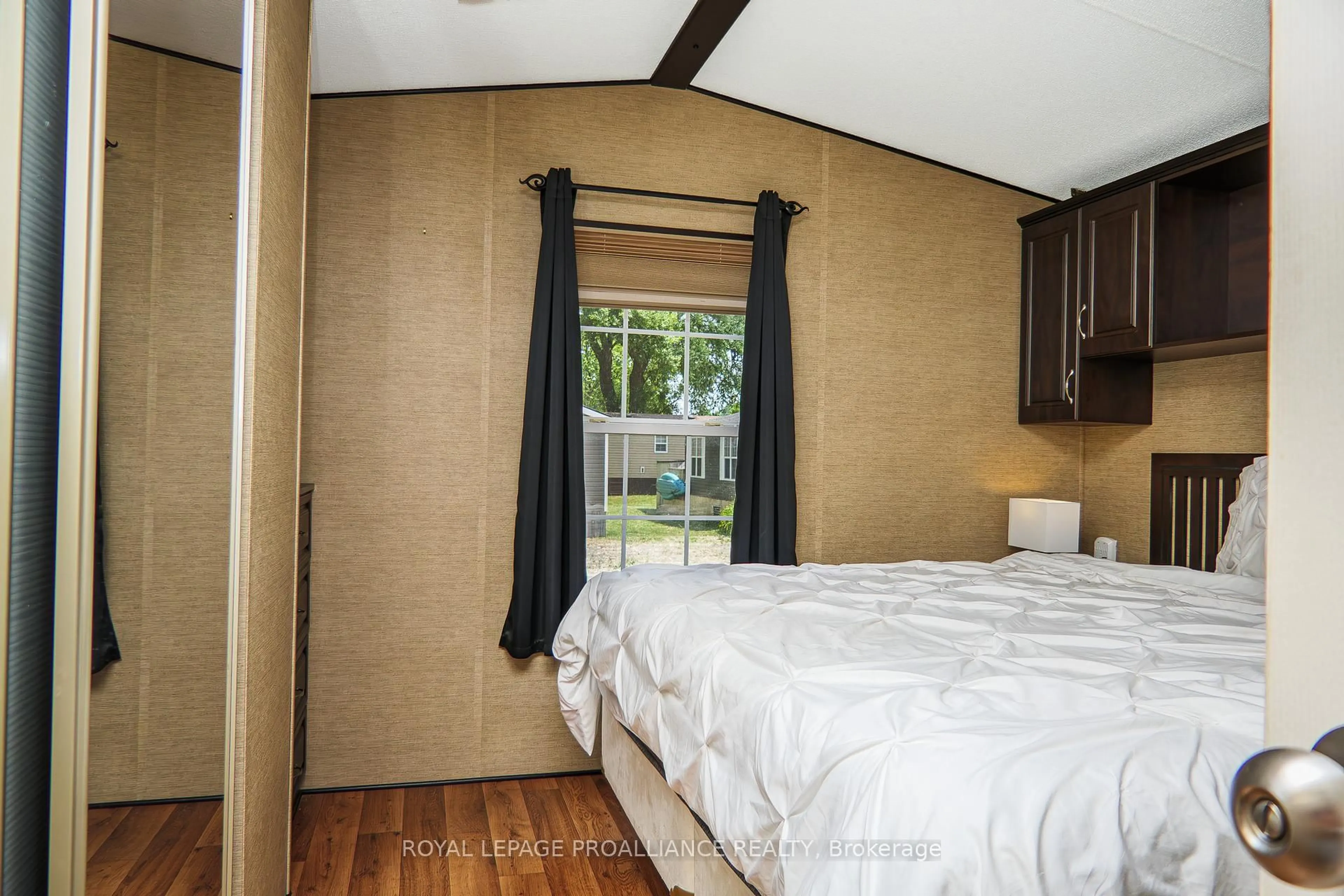 Bedroom with bed, wood/laminate floor for 486 County Road 18 #13 Beach view Lane, Prince Edward County Ontario K0K 1P0