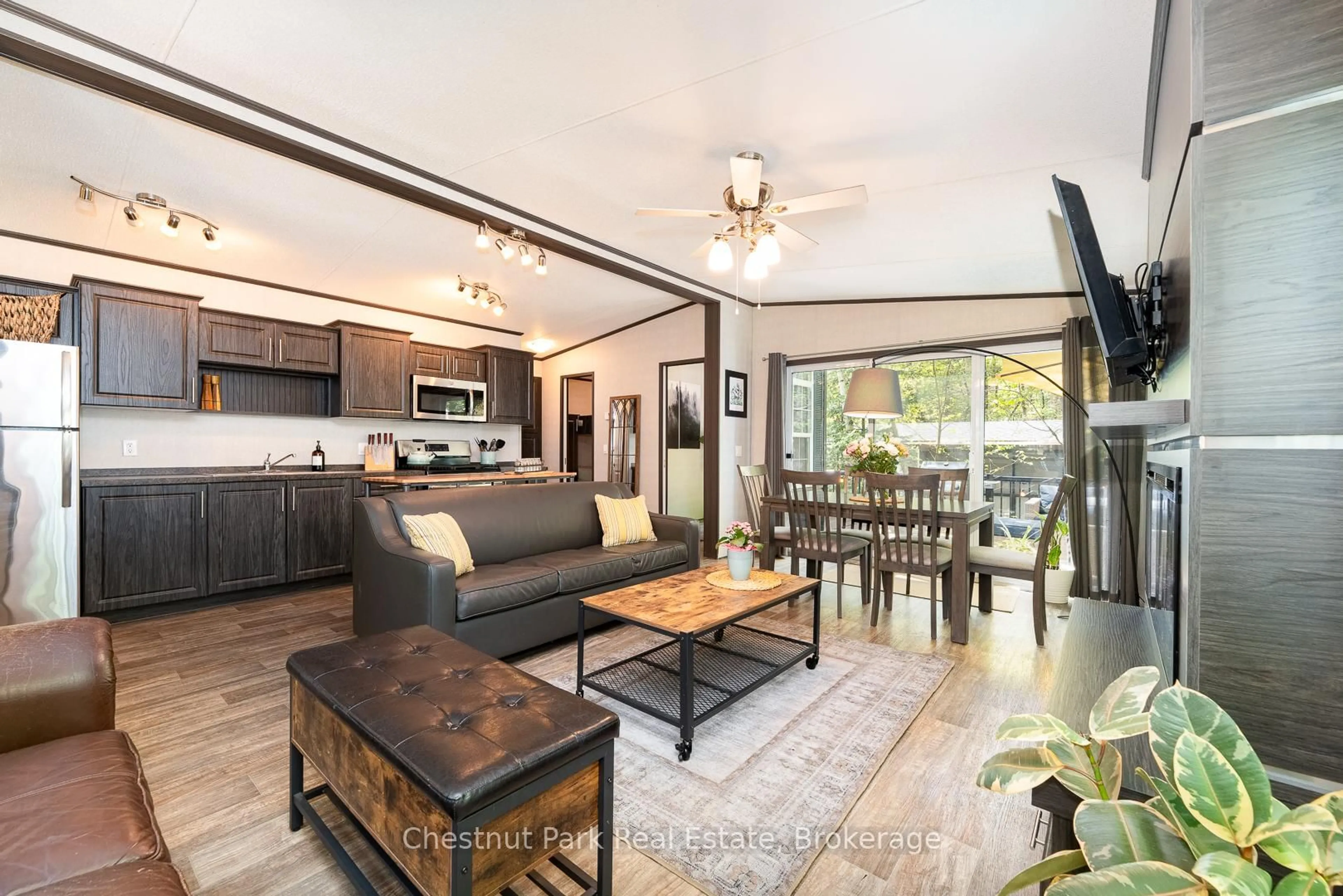 Open concept kitchen, wood/laminate floor for 1047 Bonnie Lake Camp Rd #808, Bracebridge Ontario P1L 1W9