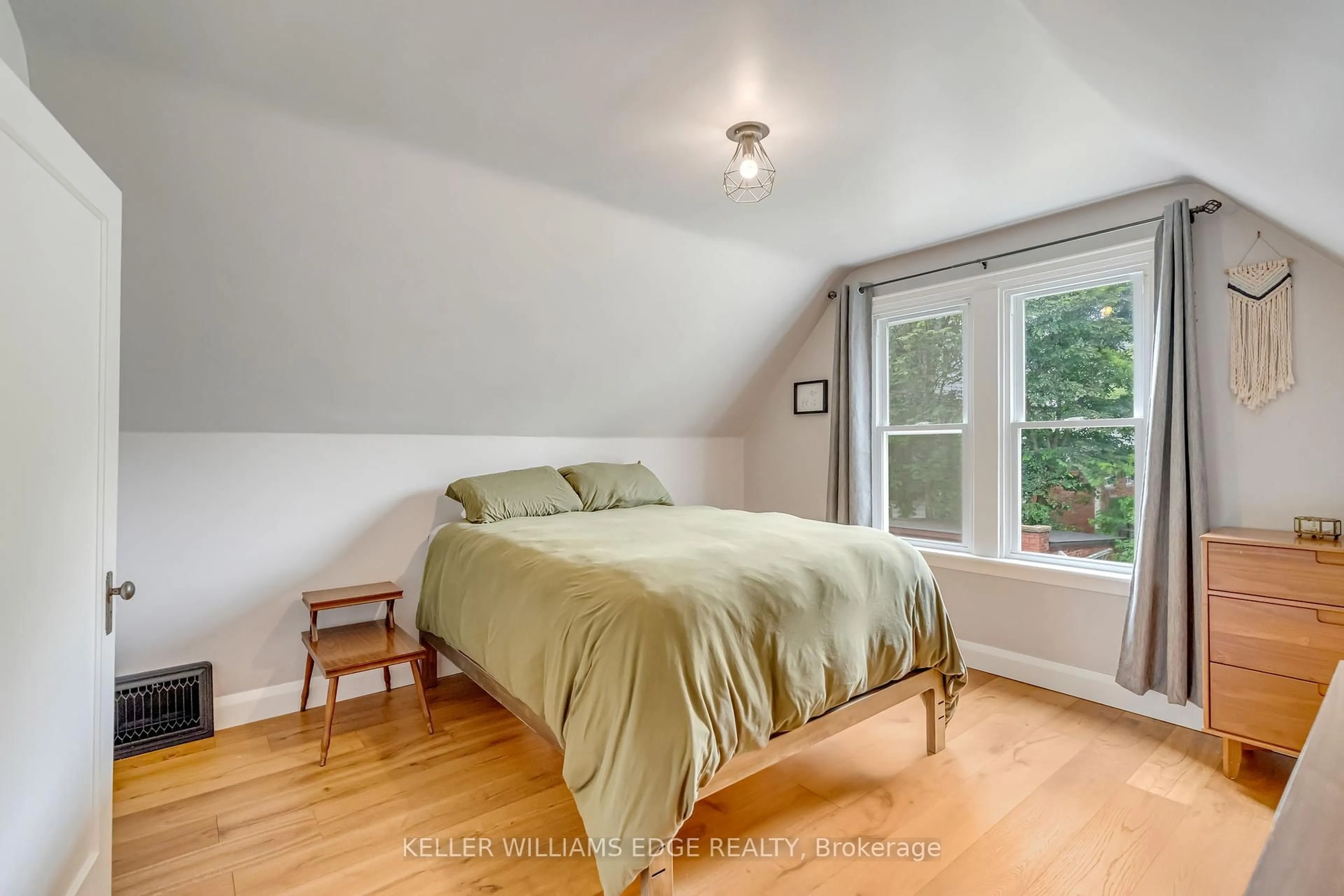 Bedroom with bed, wood/laminate floor for 52 Delaware Ave, Hamilton Ontario L8M 1T4