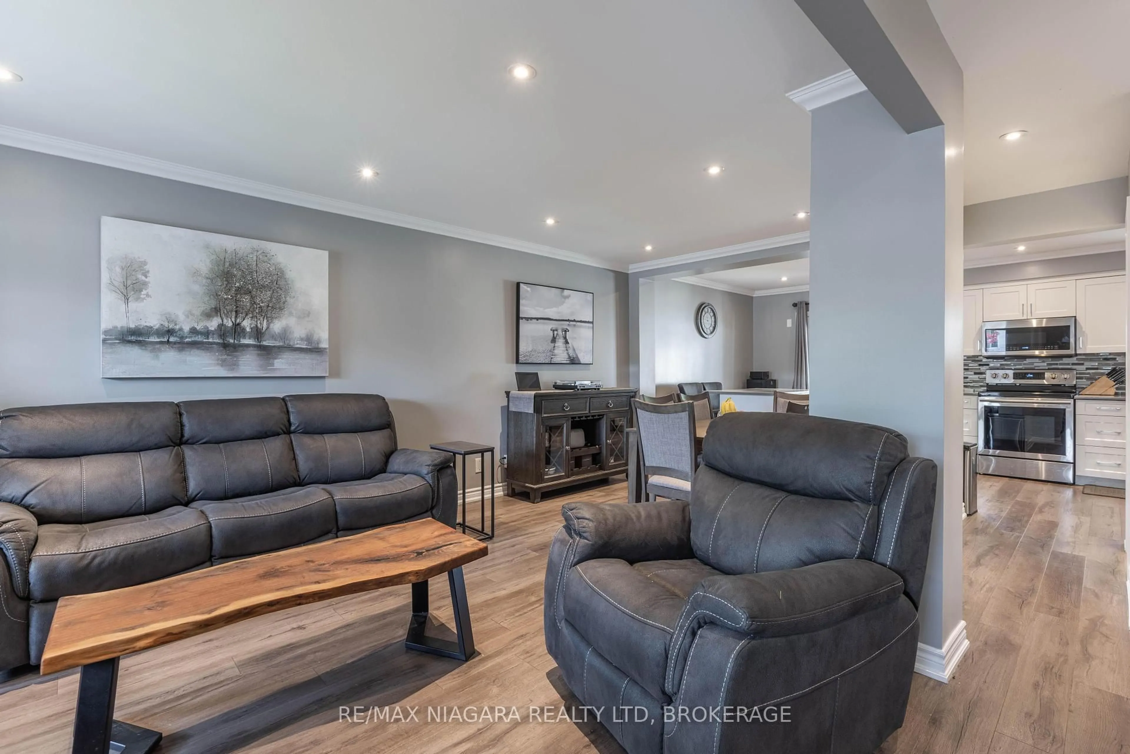 Living room with furniture, wood/laminate floor for 8 Apollo Dr, Port Colborne Ontario L3K 6B3