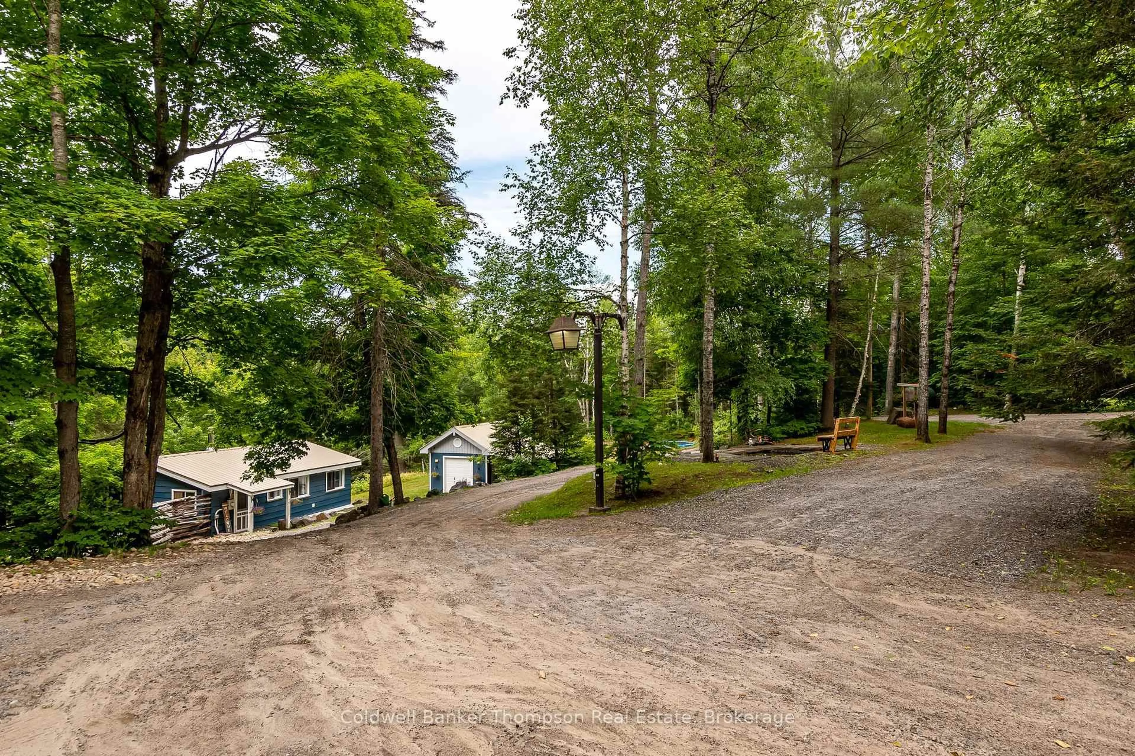 A pic from outside/outdoor area/front of a property/back of a property/a pic from drone, forest/trees view for 63 Woodland Lane, Kearney Ontario P0A 1M0