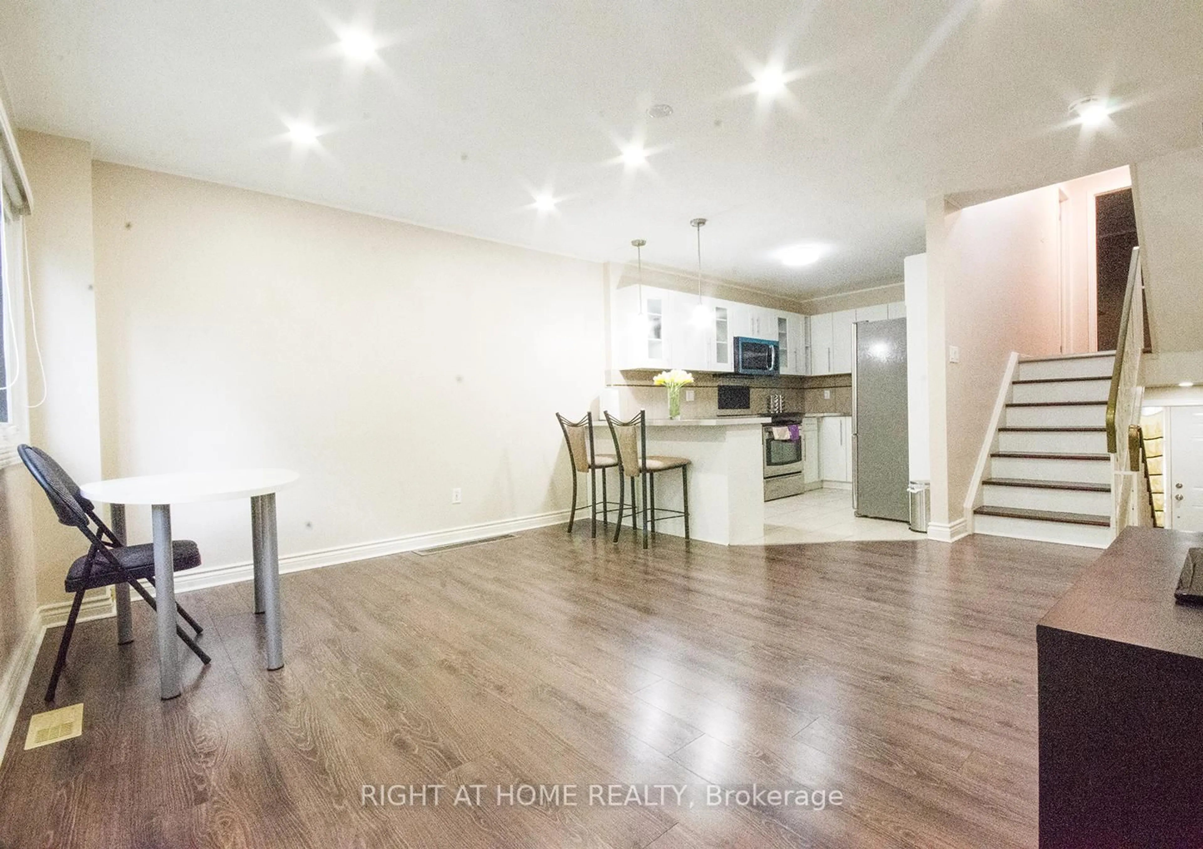 Open concept kitchen, wood/laminate floor for 35 Tybalt Cres, Ottawa Ontario K2H 8J6