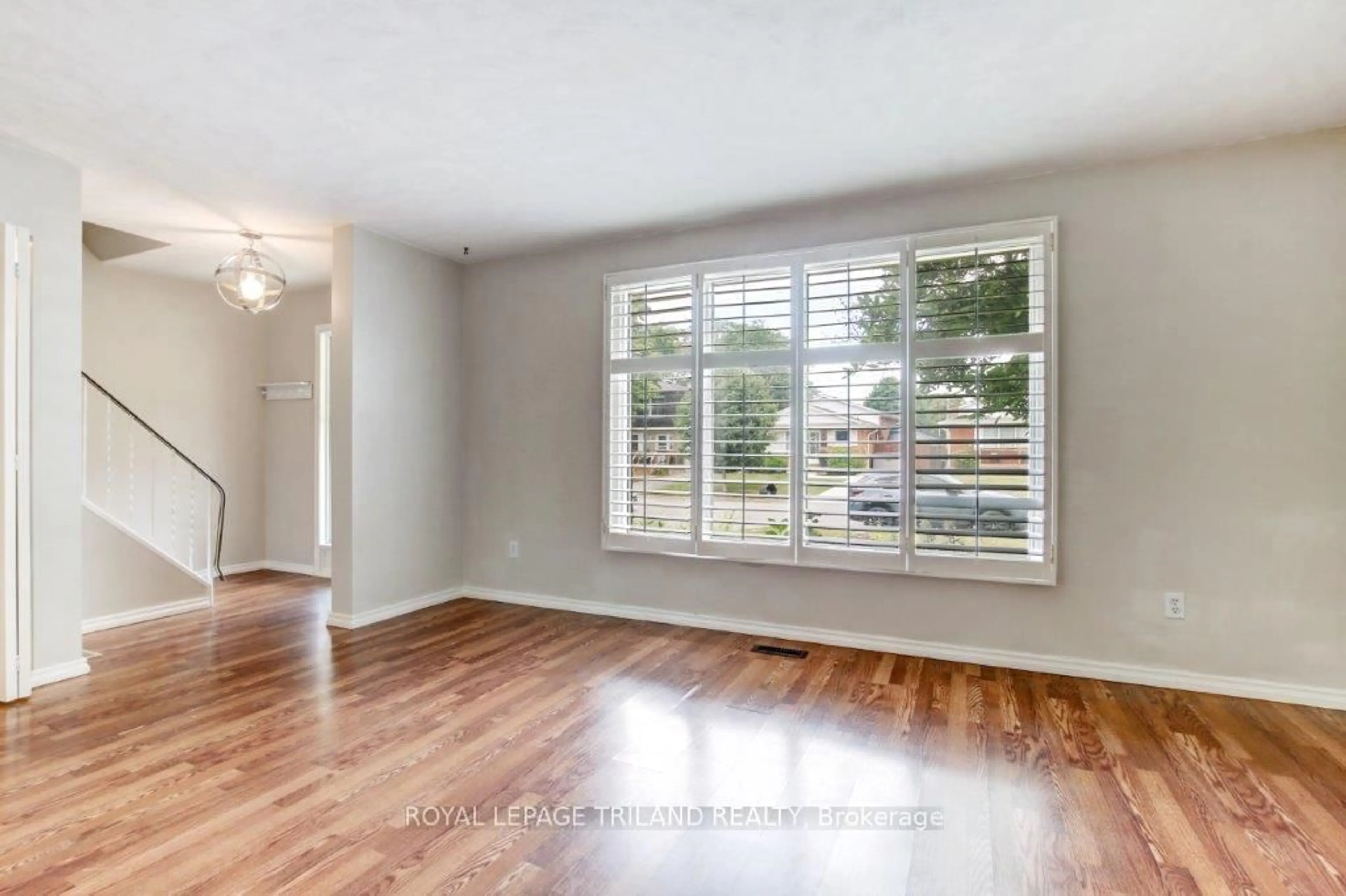 Living room with furniture, wood/laminate floor for 23 Dyer St, St. Thomas Ontario N5R 5K2