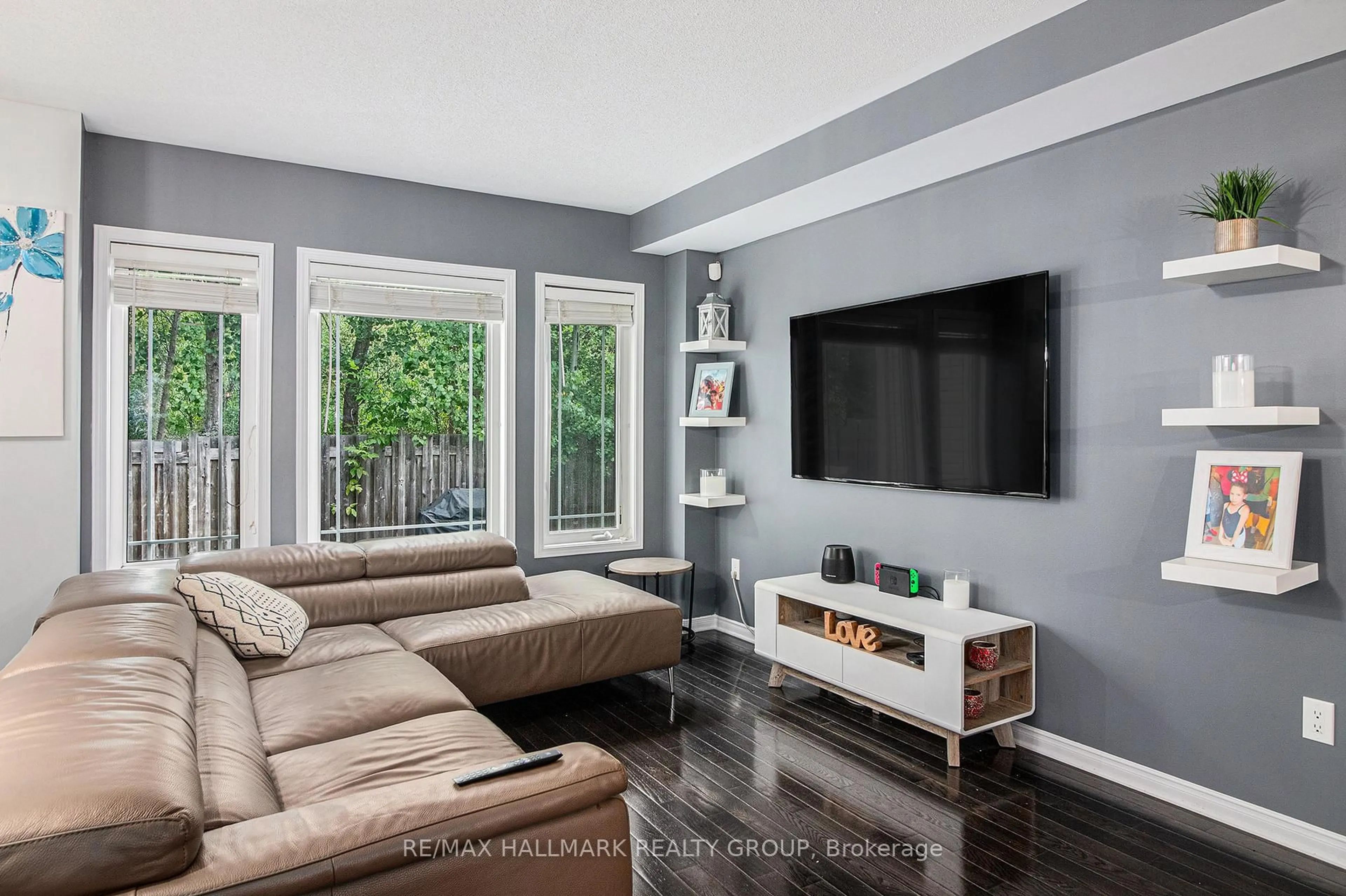 Living room with furniture, wood/laminate floor for 716 Percifor Way, Ottawa Ontario K1W 0E4