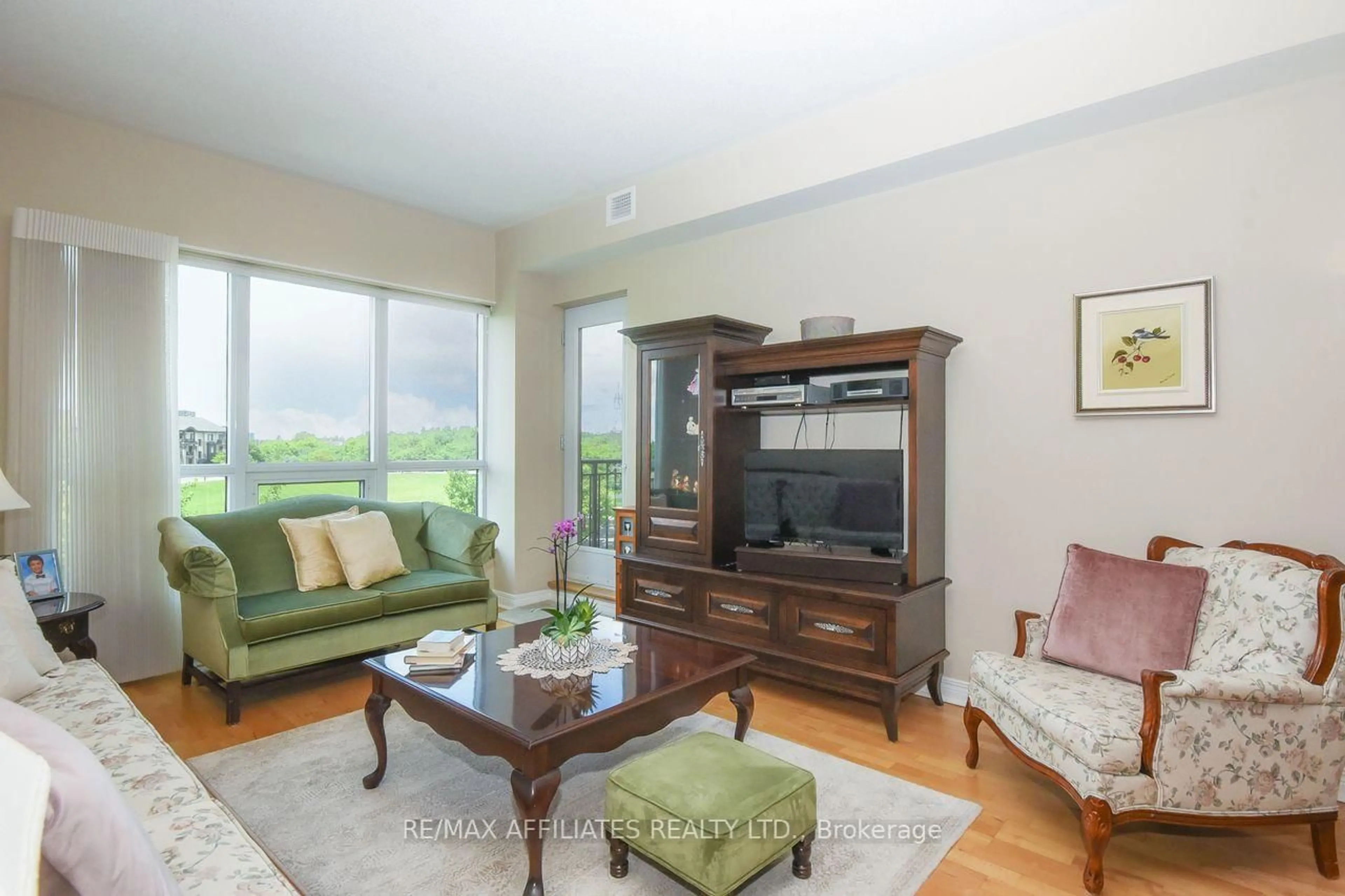 Living room with furniture, wood/laminate floor for 905 Beauparc Private #317, Ottawa Ontario K1J 0A1