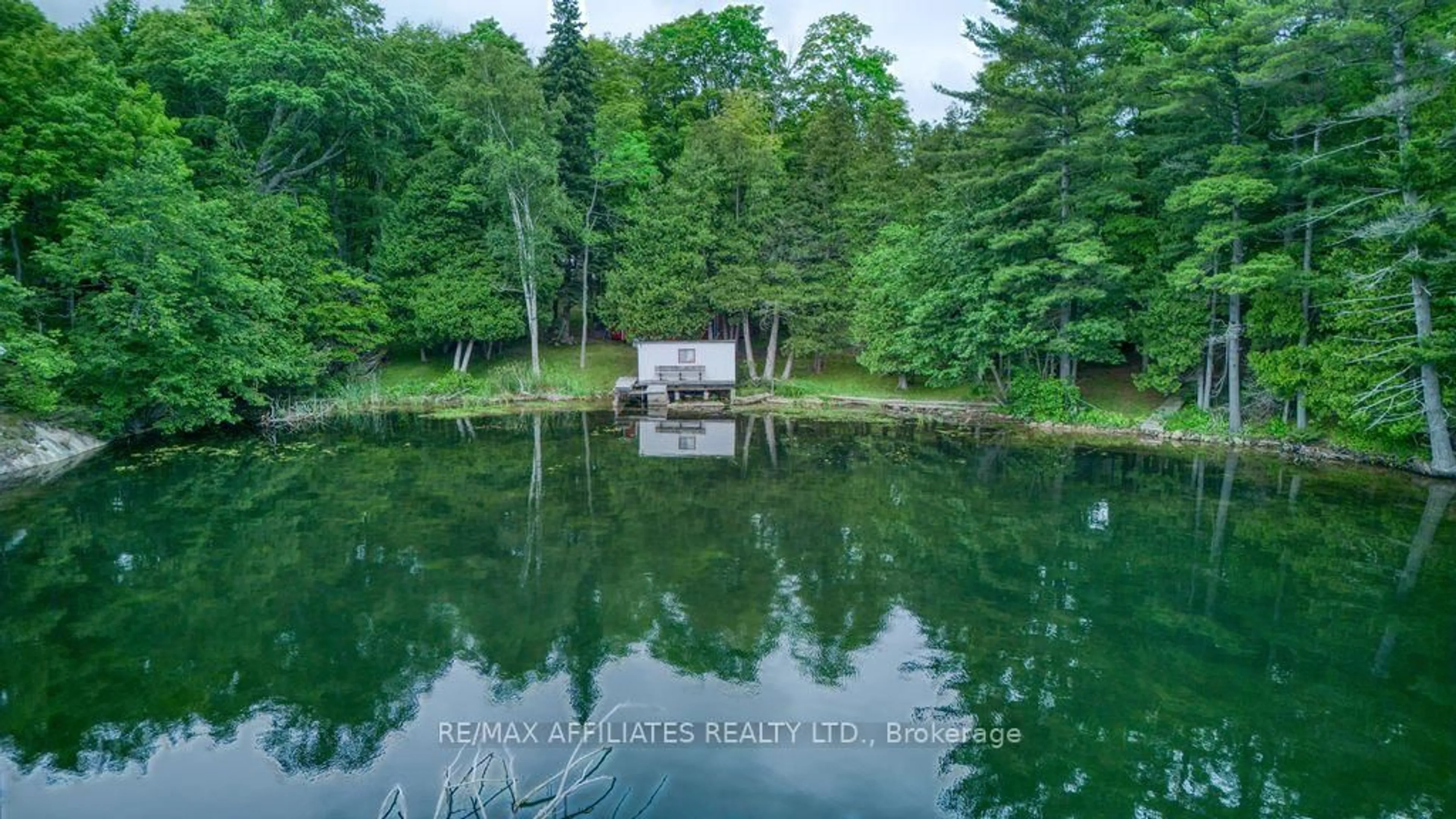 A pic from outside/outdoor area/front of a property/back of a property/a pic from drone, water/lake/river/ocean view for 323 Burns Rd, Godfrey Ontario K0H 1T0