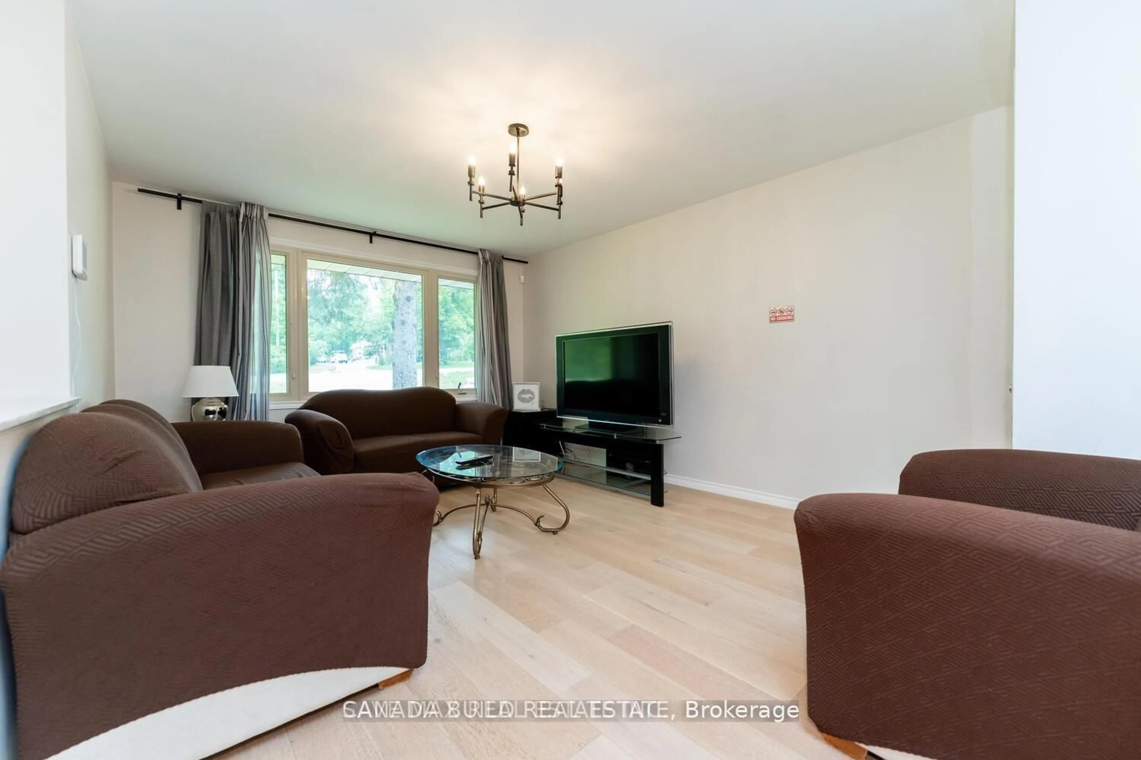 Living room with furniture, wood/laminate floor for 3220 Lakefield Rd, Selwyn Ontario K9J 6X5