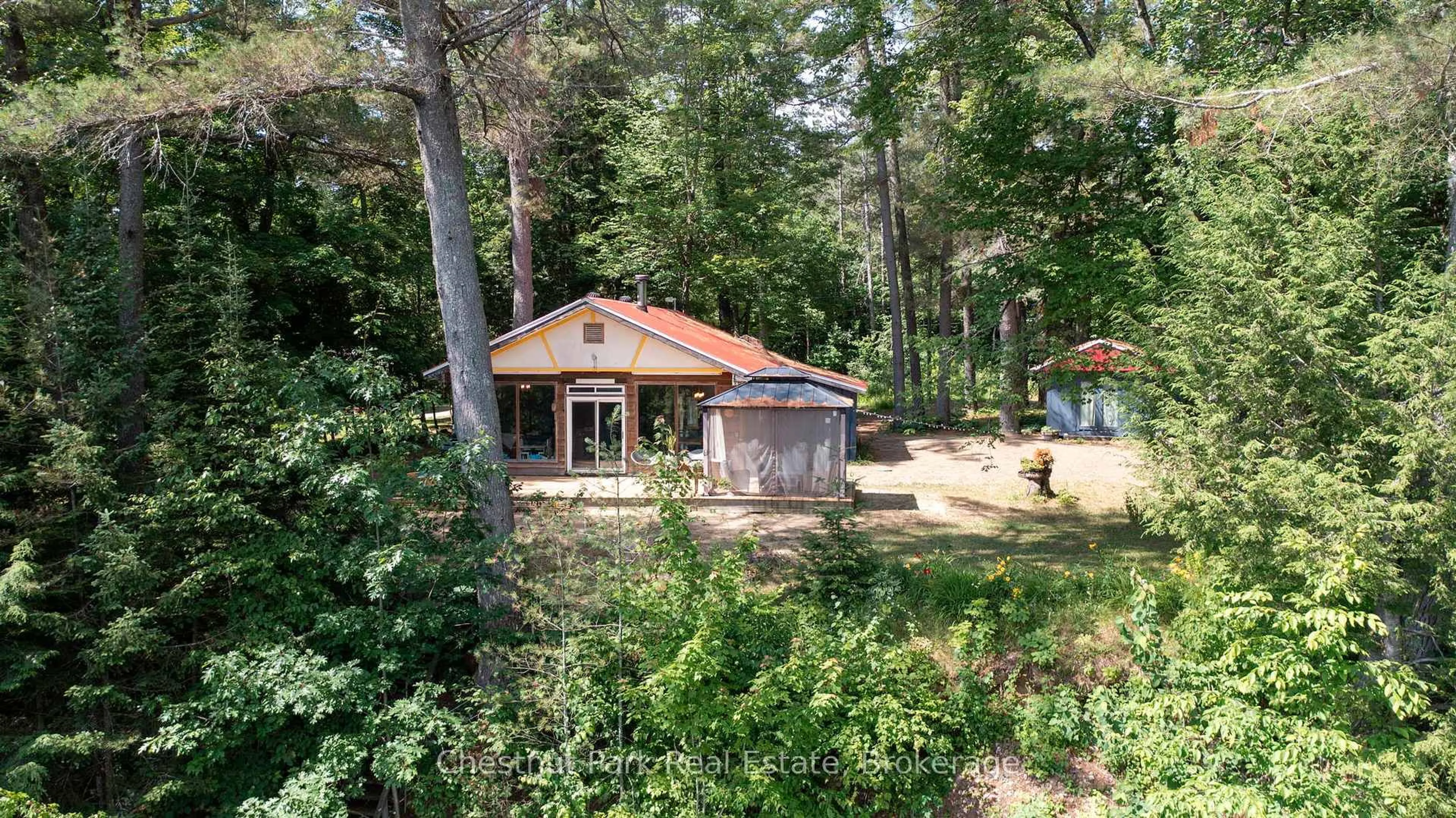 A pic from outside/outdoor area/front of a property/back of a property/a pic from drone, forest/trees view for 1277 Sherwood Forest Rd, Bracebridge Ontario P1L 1X3