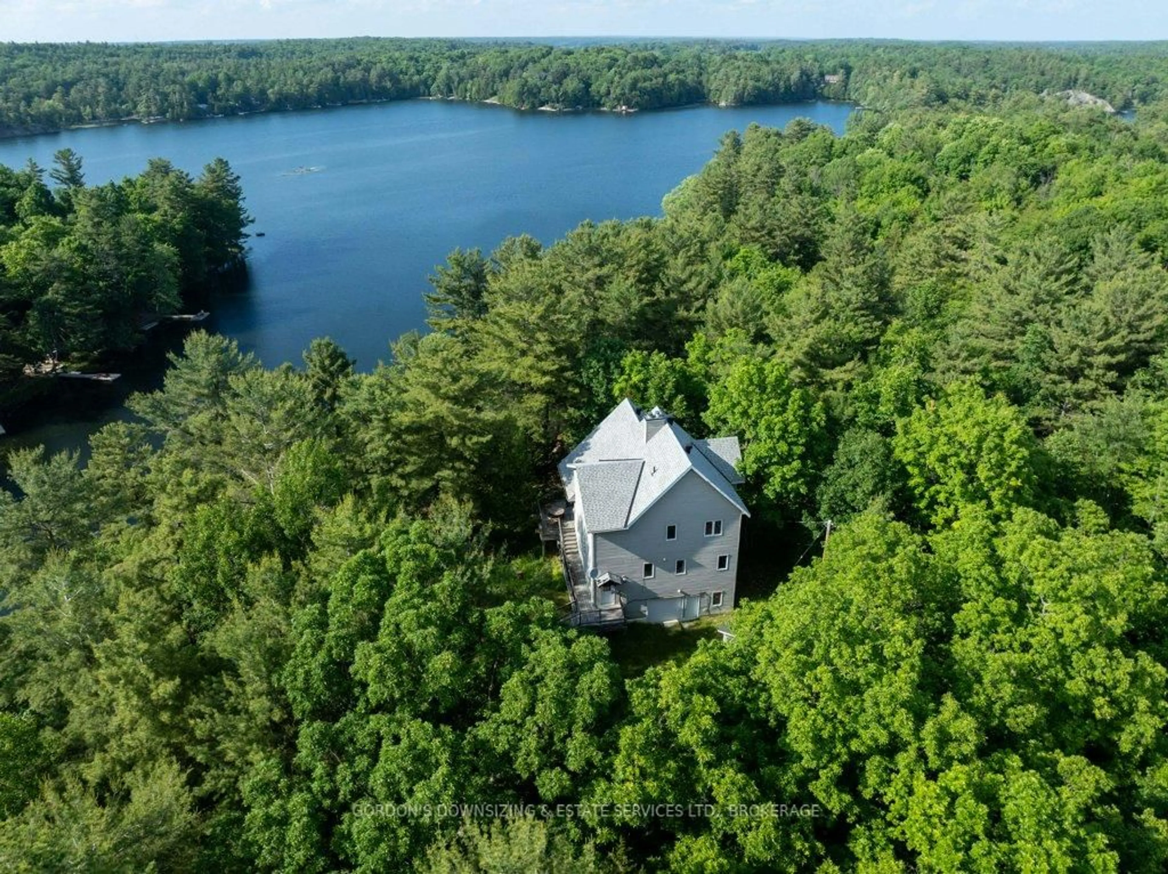 A pic from outside/outdoor area/front of a property/back of a property/a pic from drone, water/lake/river/ocean view for 1023 Neva Lane, Frontenac Ontario K9H 2L0