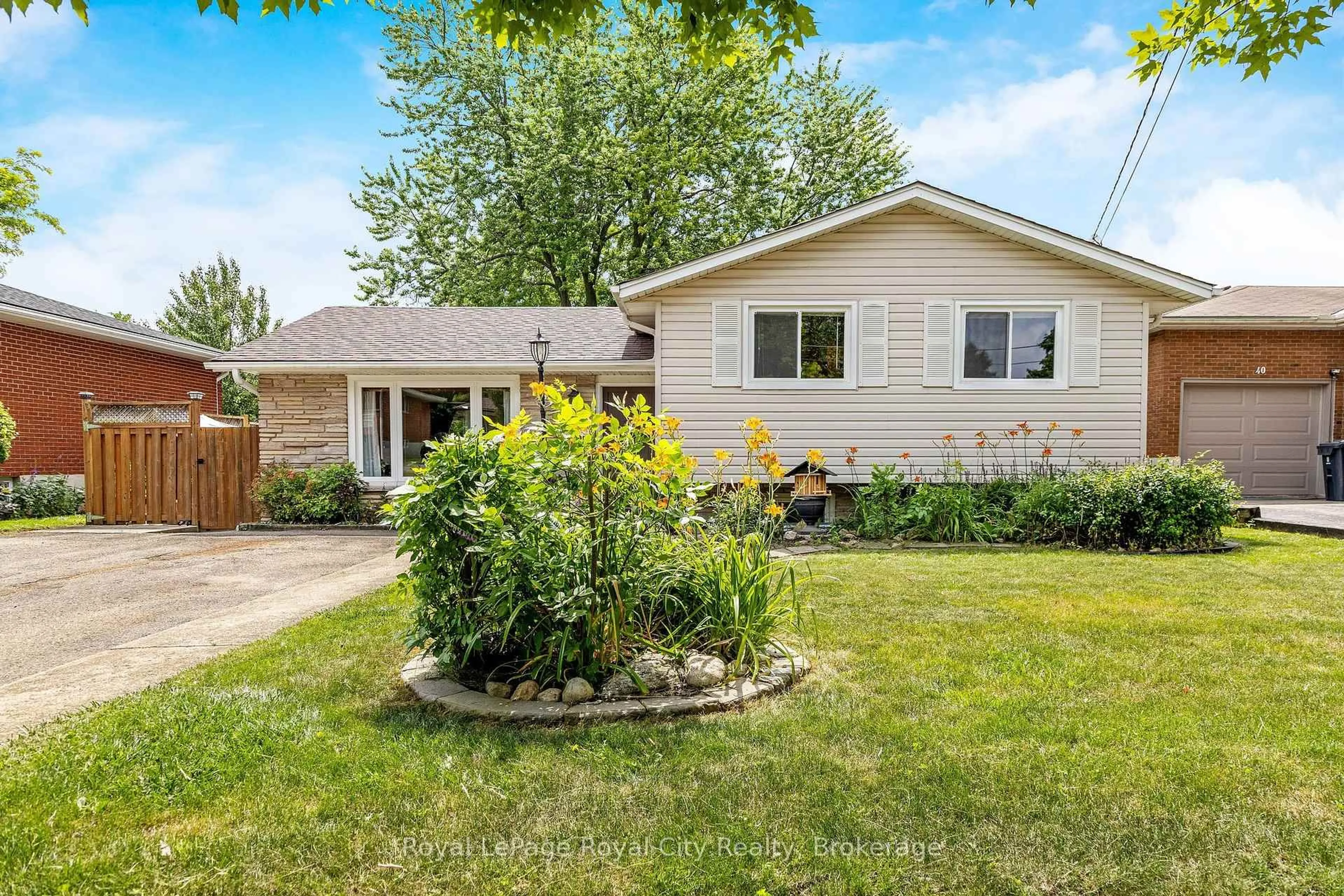 Home with vinyl exterior material, street for 38 Algoma Dr, Guelph Ontario N1E 1C7