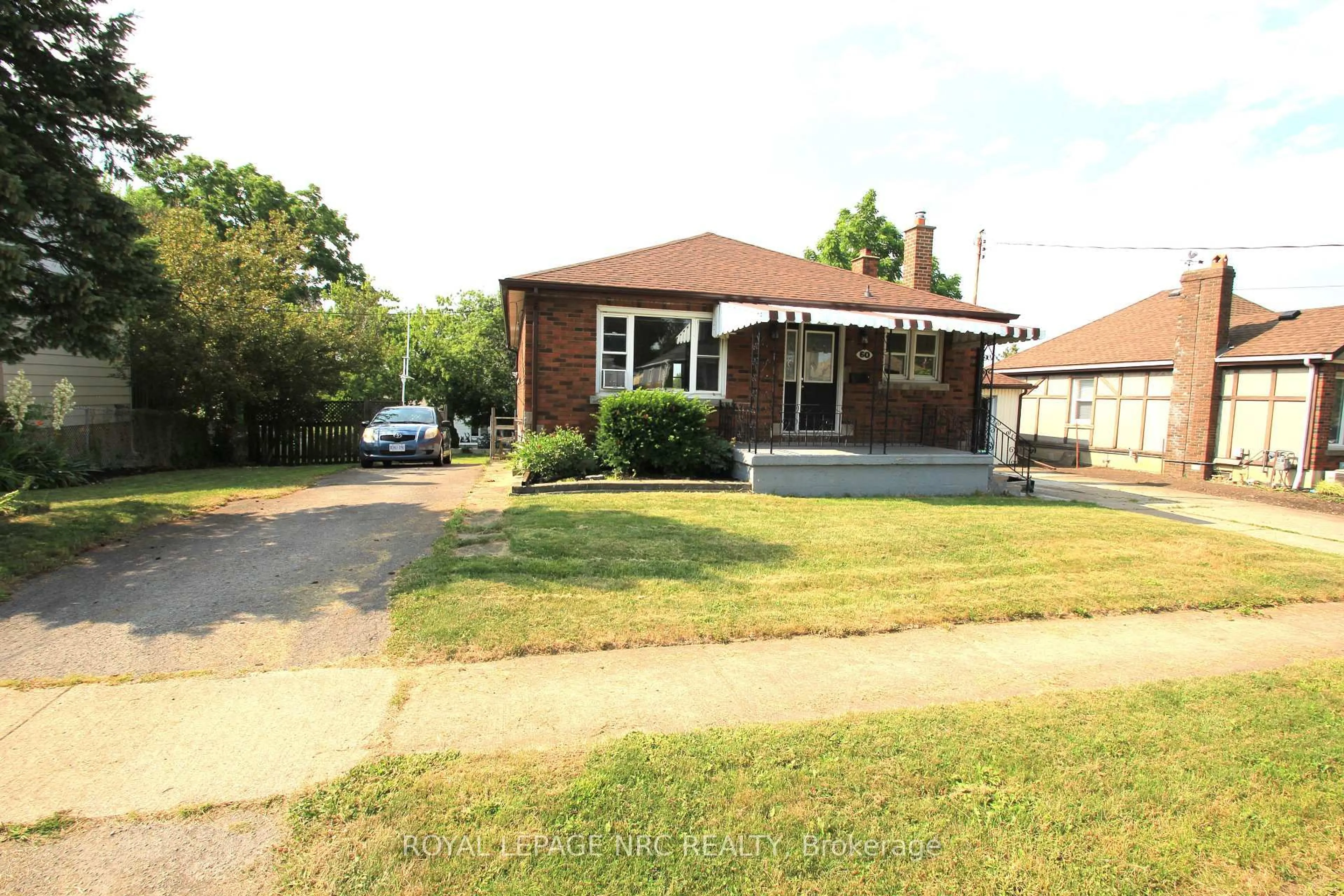 Home with brick exterior material, street for 60 Michael Ave, St. Catharines Ontario L2T 1S3