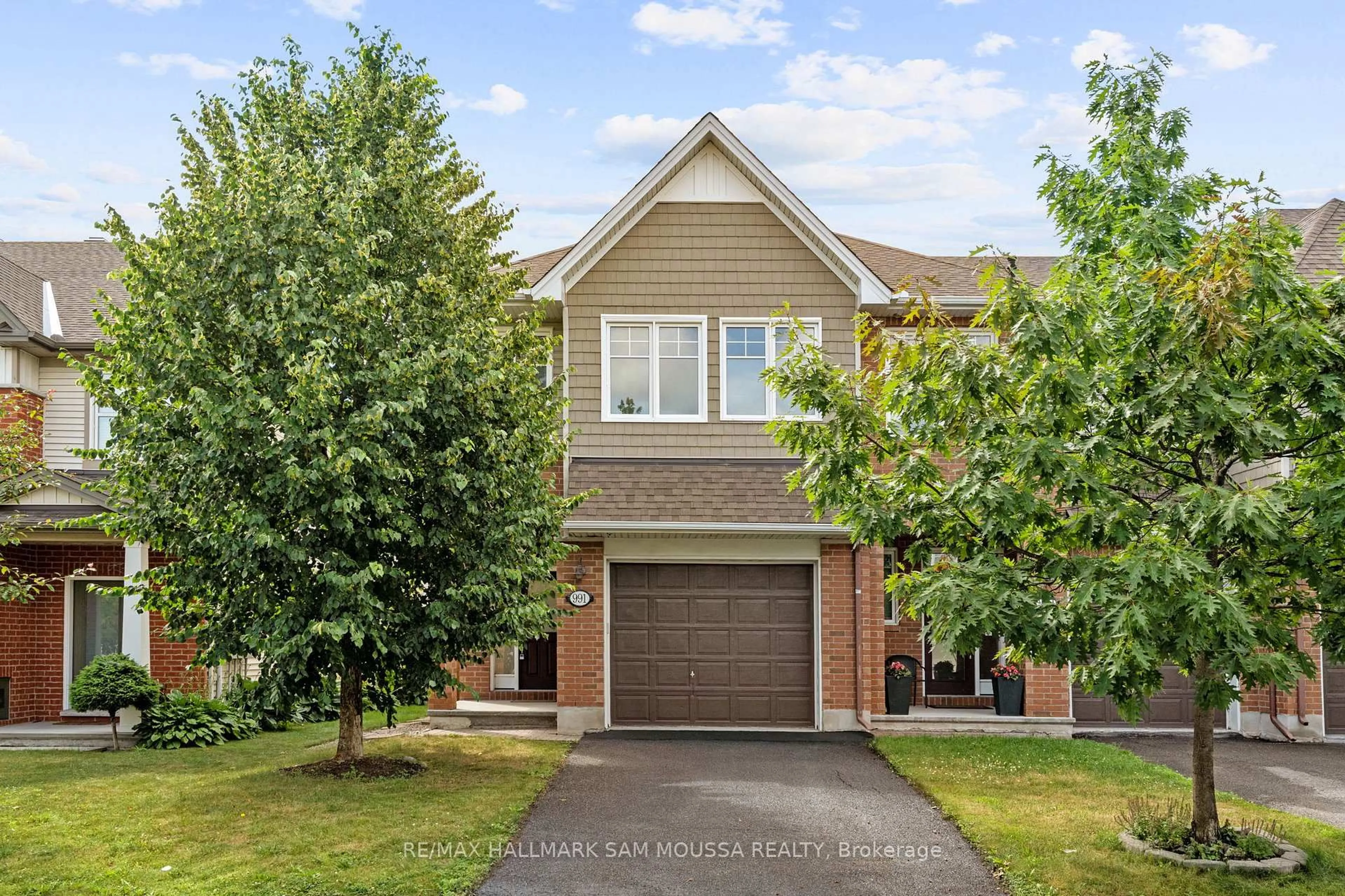Home with brick exterior material, street for 991 Bunchberry Way, Ottawa Ontario K1T 0L6