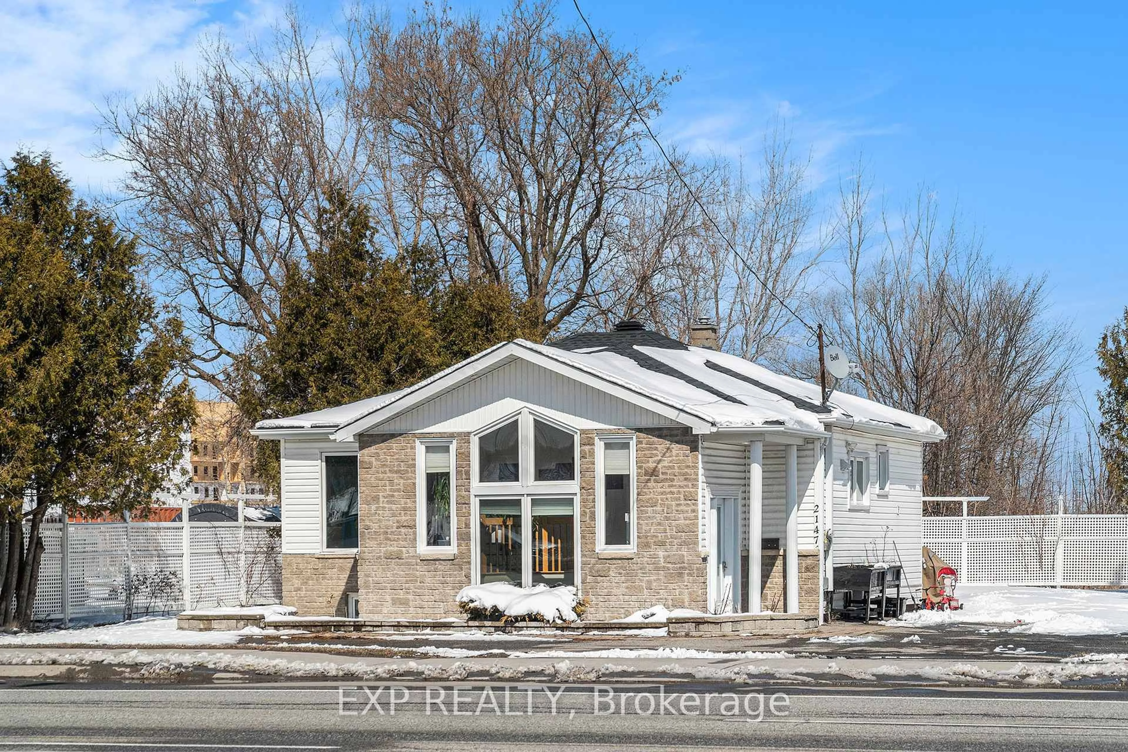 Home with vinyl exterior material, street for 2147 Mer Bleue Rd, Ottawa Ontario K4A 3T9