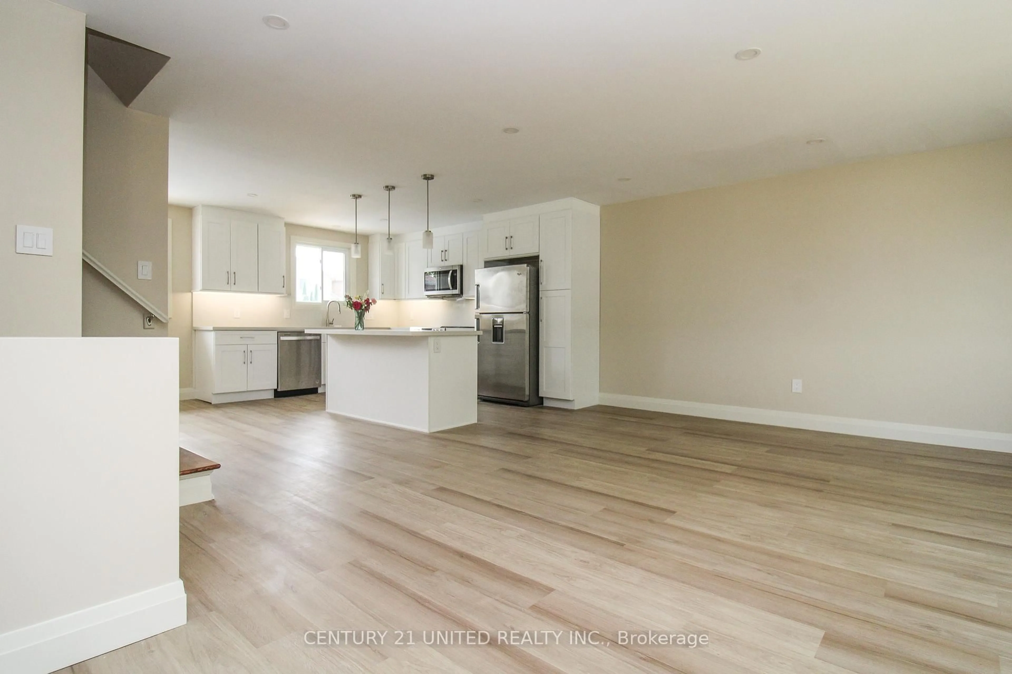 Open concept kitchen, wood/laminate floor for 594 Saugeen Cres, Peterborough South Ontario K9J 1K1