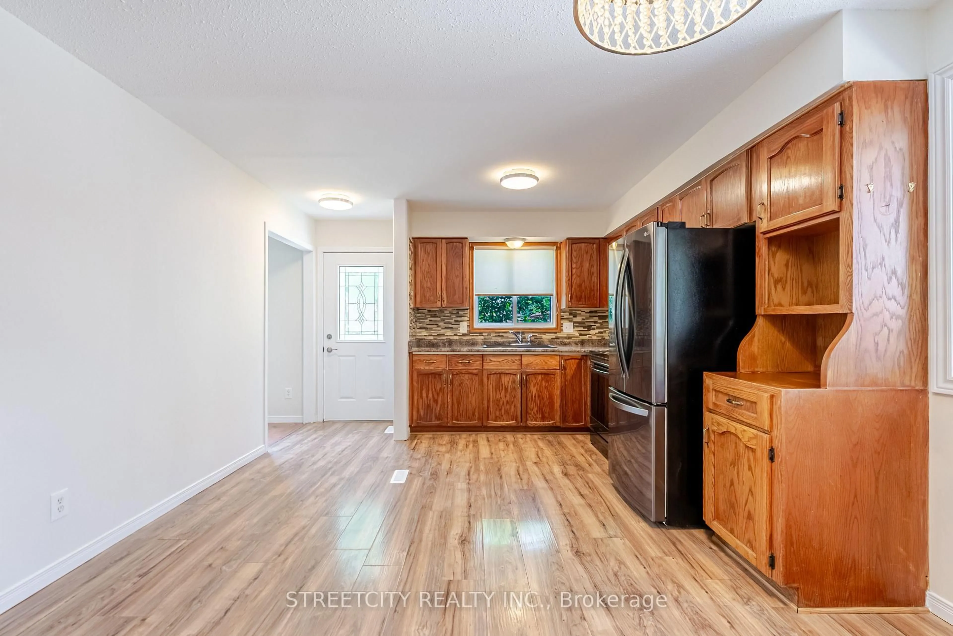 Open concept kitchen, wood/laminate floor for 20 Fairchild Cres, London South Ontario N6E 3E2