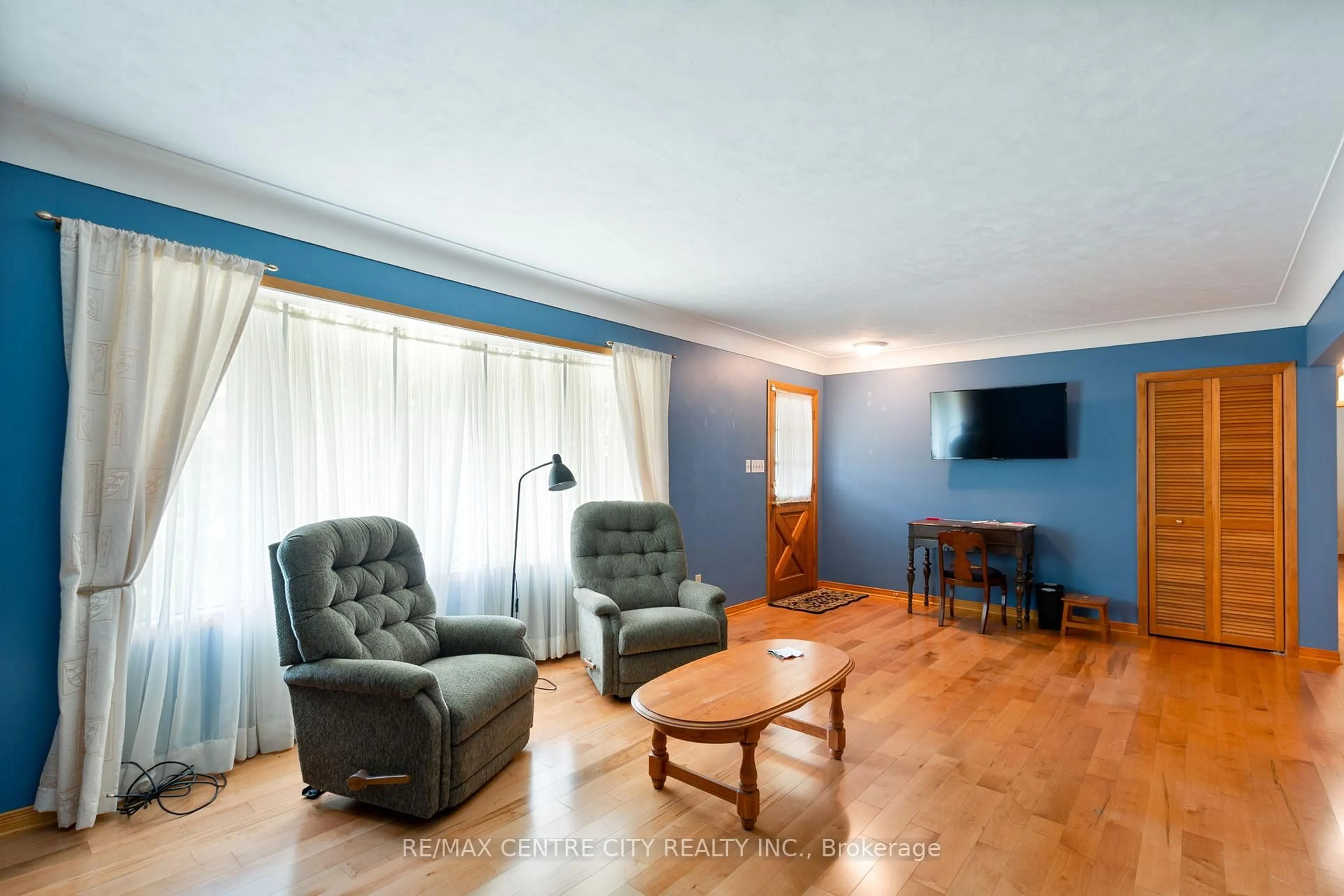 Living room with furniture, wood/laminate floor for 233 Amy St, Southwest Middlesex Ontario N0L 2N0