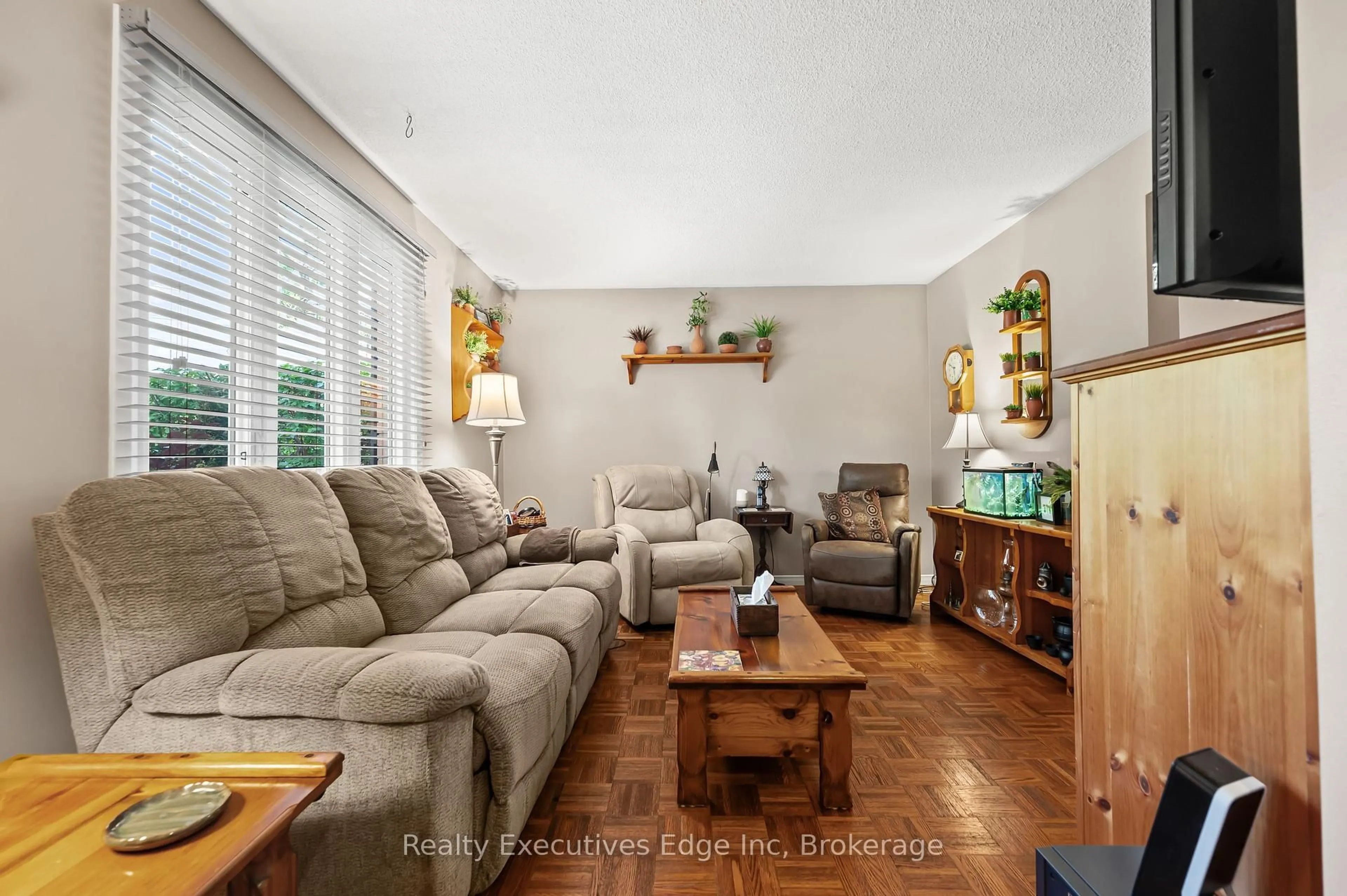 Living room with furniture, wood/laminate floor for 212 Edinburgh Rd, Guelph Ontario N1H 5R9