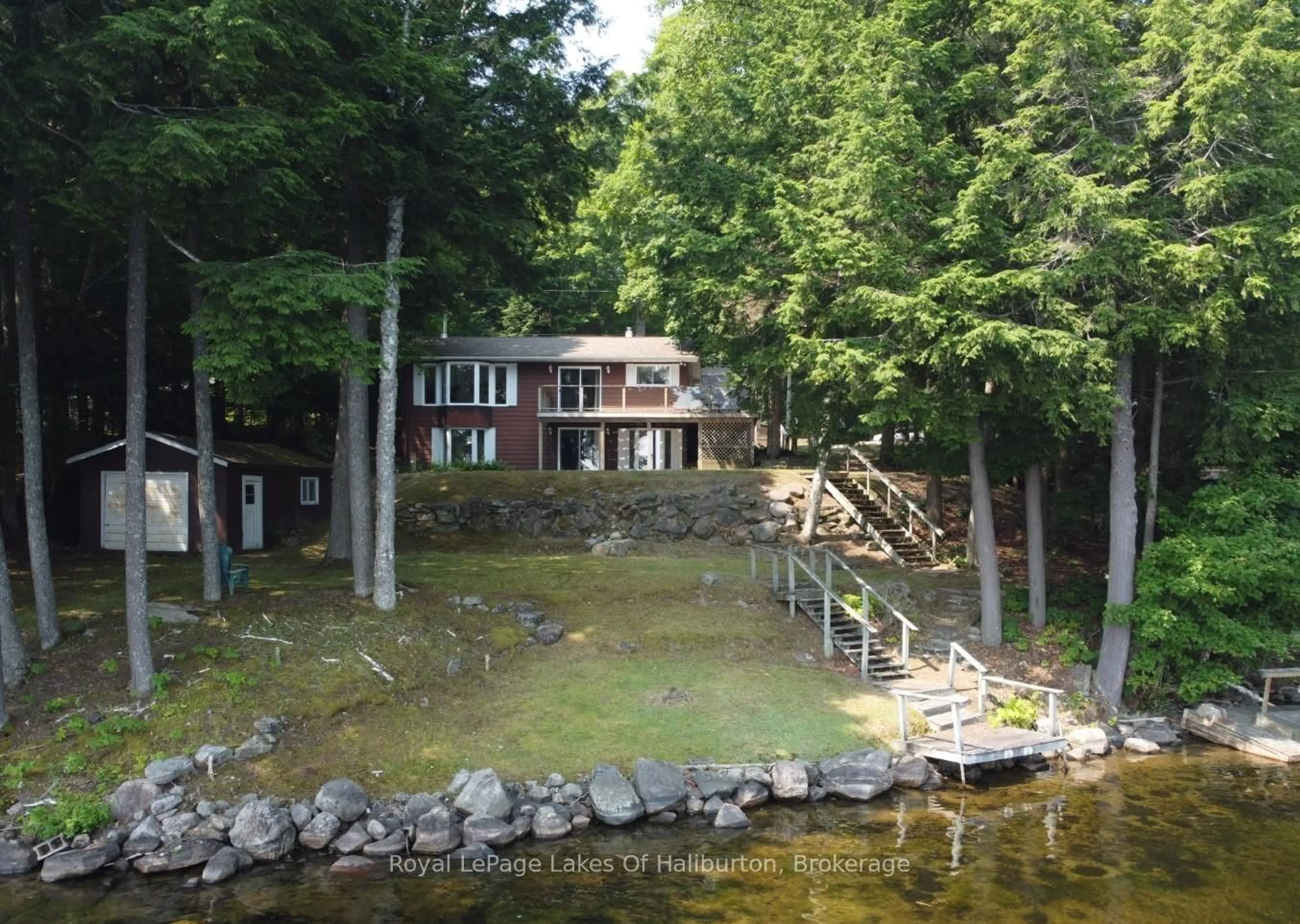 A pic from outside/outdoor area/front of a property/back of a property/a pic from drone, water/lake/river/ocean view for 1051 Autumn Lane, Dysart et al Ontario K0M 1S0