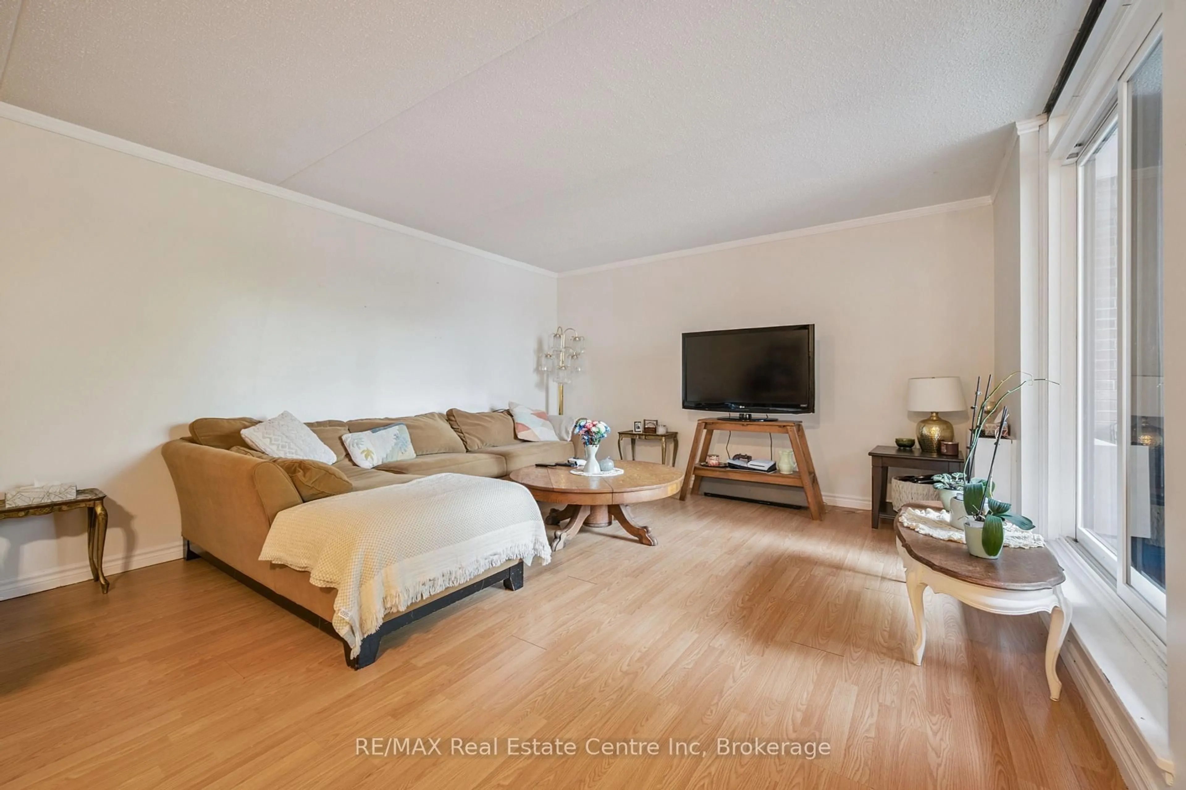 Living room with furniture, unknown for 65 Silvercreek Pkwy #310, Guelph Ontario N1H 7R9