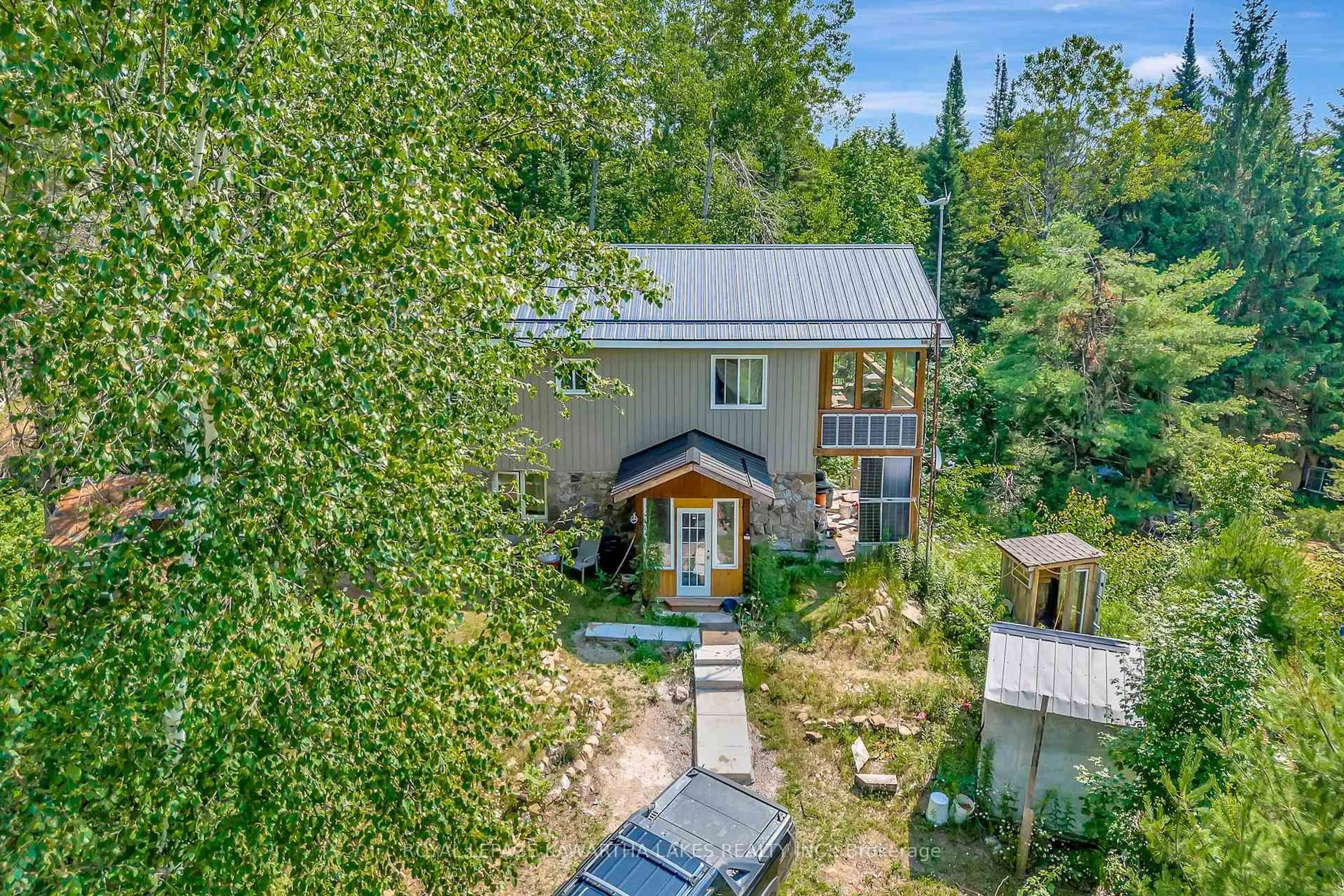 A pic from outside/outdoor area/front of a property/back of a property/a pic from drone, forest/trees view for 707 Galway Rd, Trent Lakes Ontario K0M 2A0