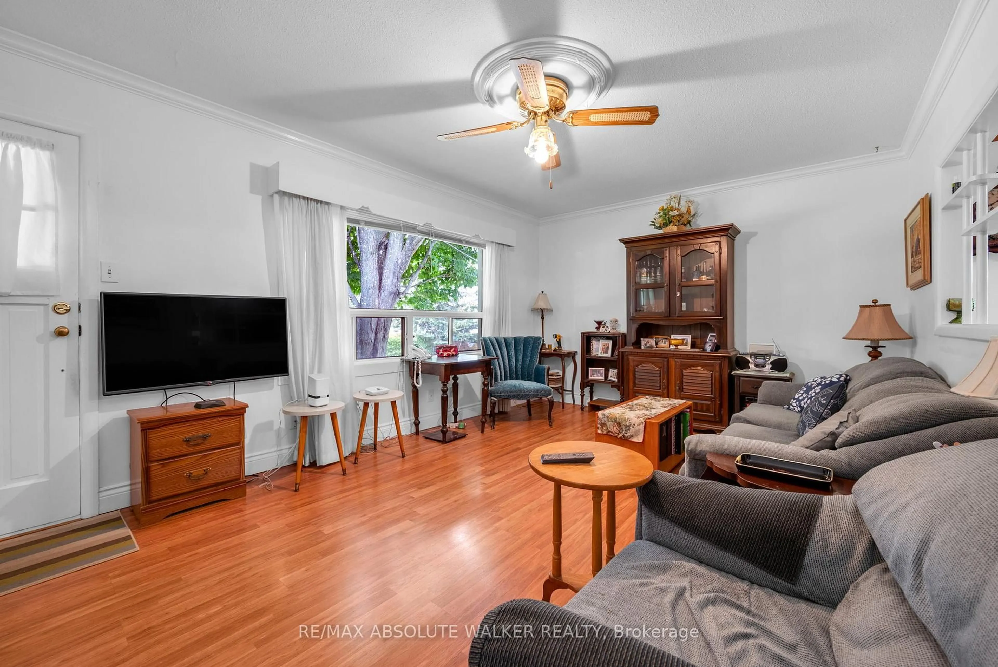 Living room with furniture, wood/laminate floor for 1121 Cholette Cres, Orleans Ontario K1C 1T4