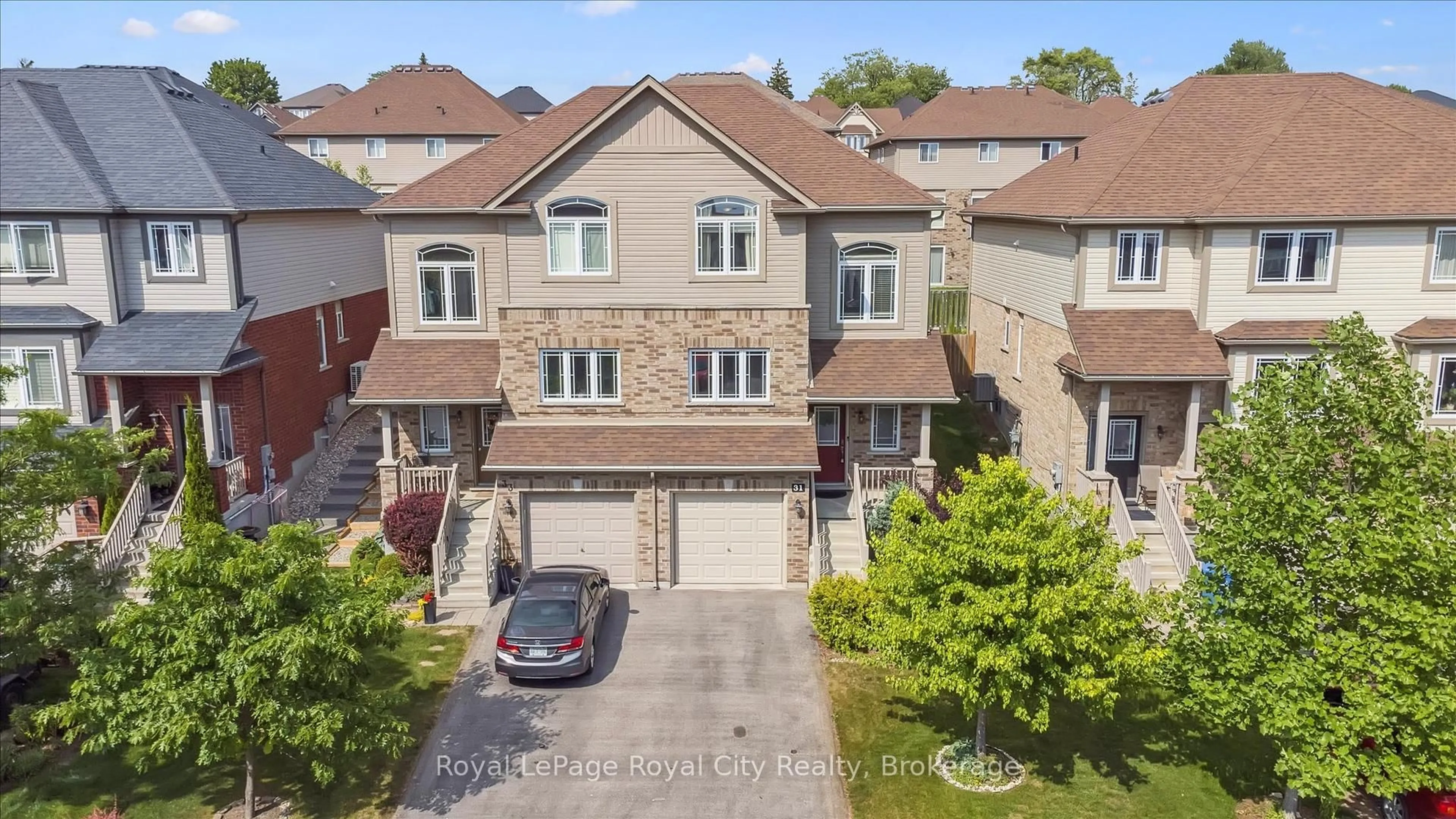 A pic from outside/outdoor area/front of a property/back of a property/a pic from drone, street for 31 Oakes Cres, Guelph Ontario N1E 0J6