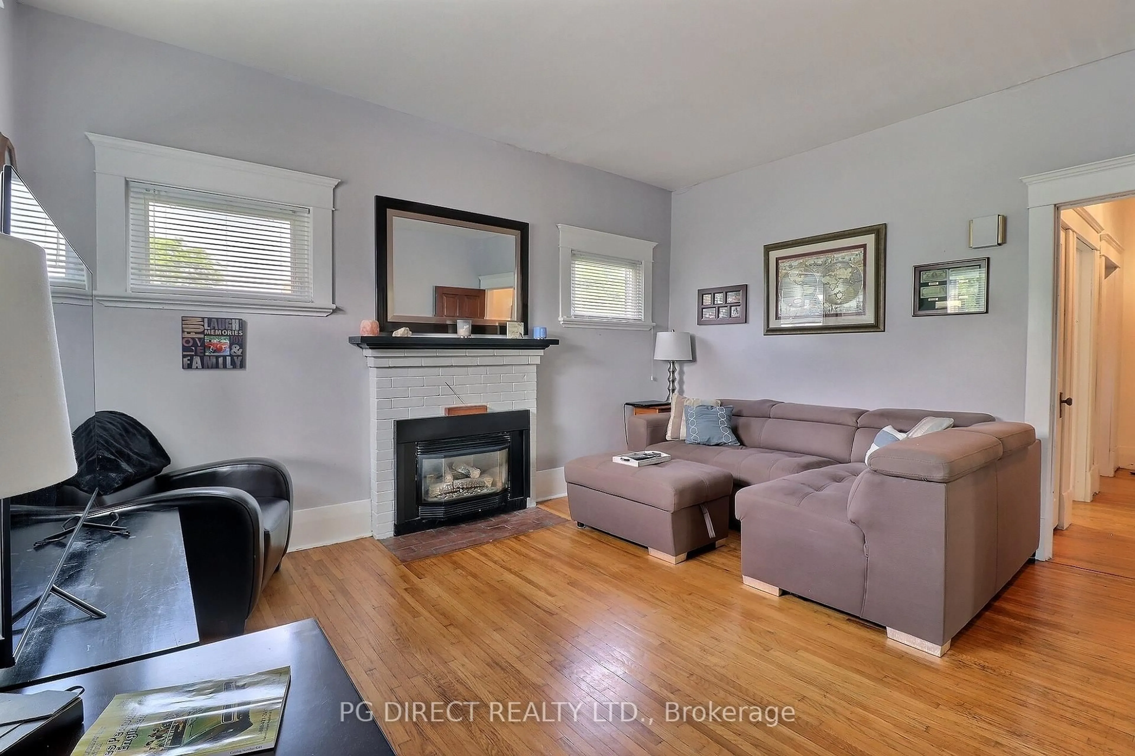 Living room with furniture, wood/laminate floor for 7084 Longwoods Rd, London South Ontario N6P 1P9