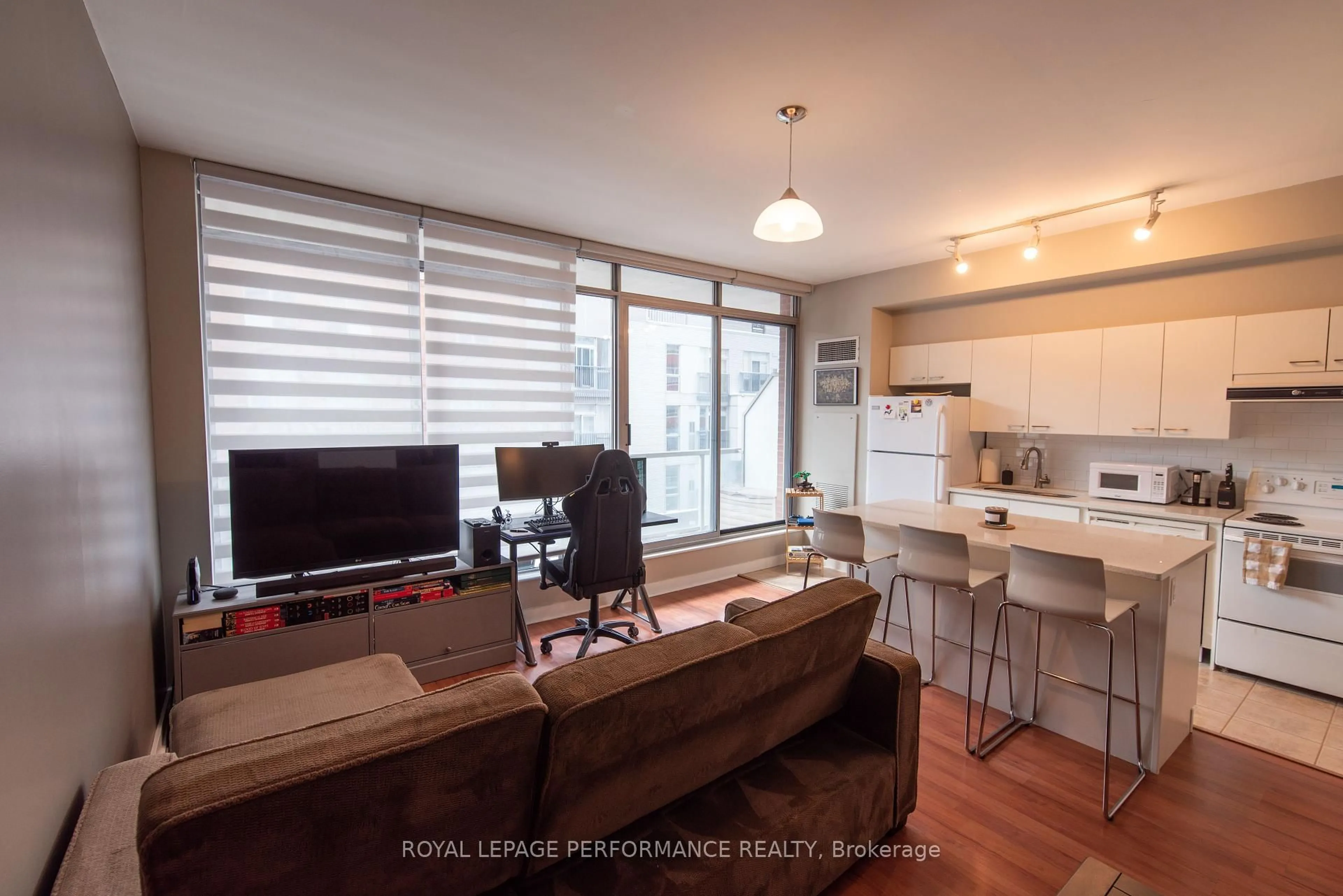 Living room with furniture, wood/laminate floor for 383 Cumberland St #401, Ottawa Ontario K1N 1J7