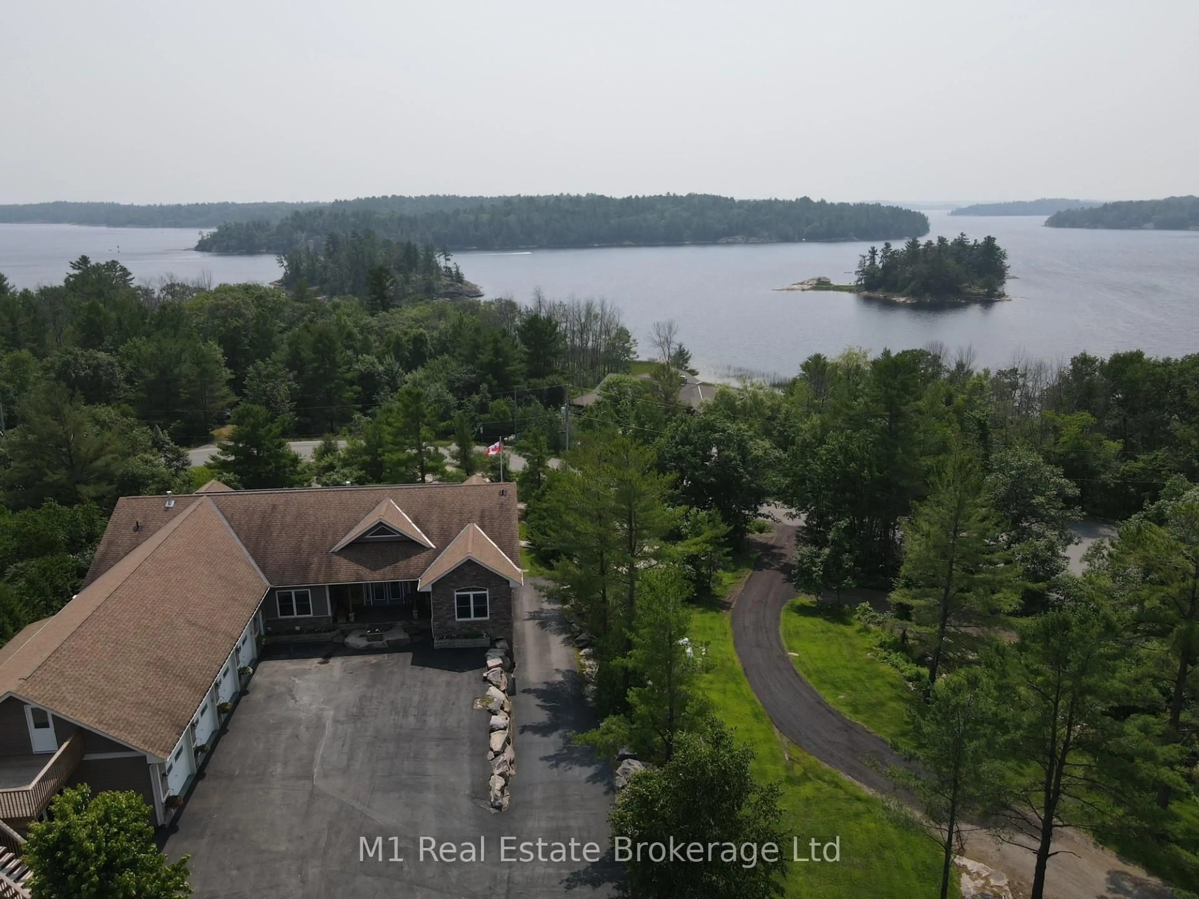 A pic from outside/outdoor area/front of a property/back of a property/a pic from drone, water/lake/river/ocean view for 65 Big Sound Rd Rd, McDougall Ontario P0G 1G0