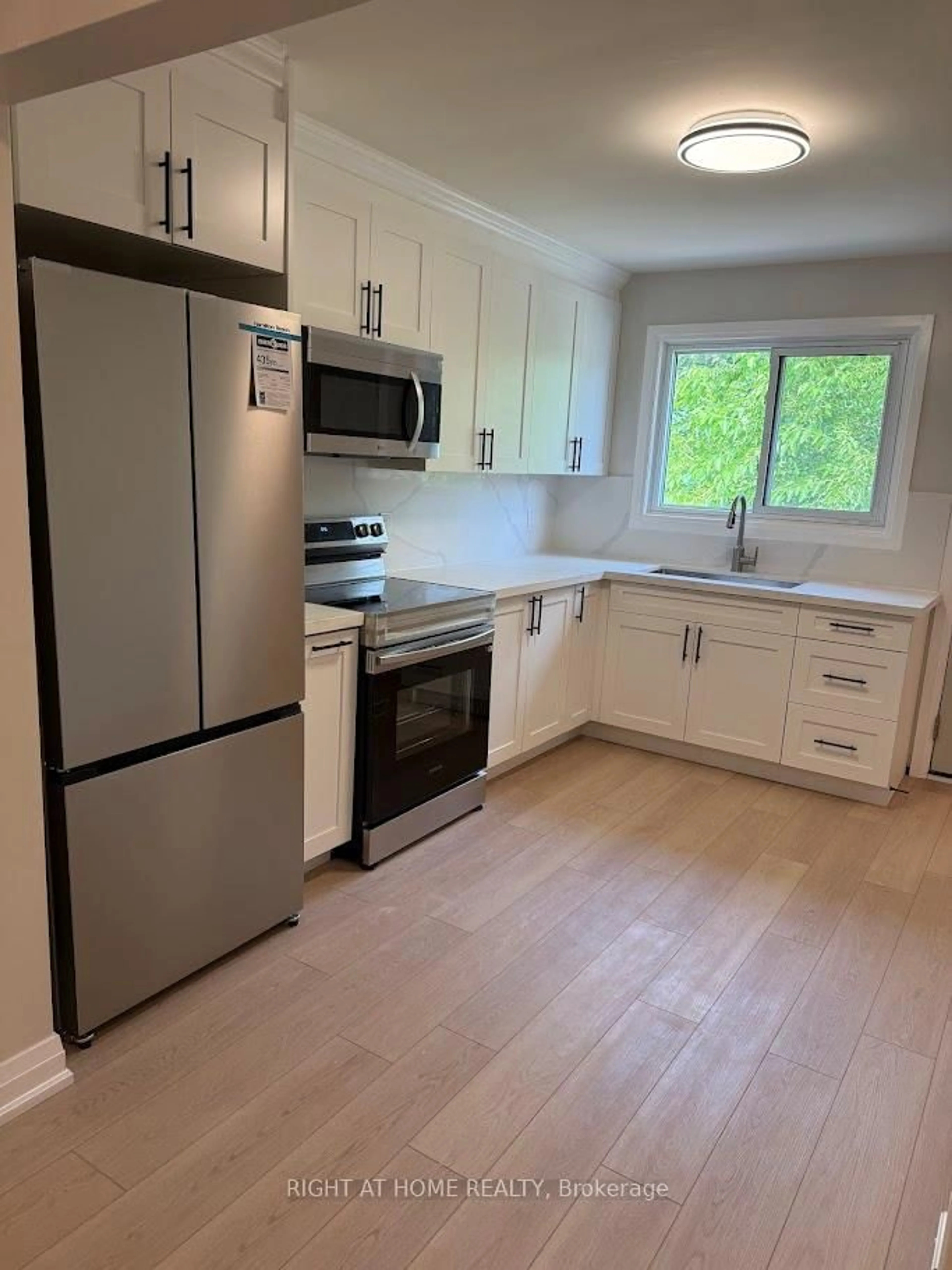 Open concept kitchen, wood/laminate floor for 1153 Johnson St, Kingston Ontario K7M 2N9
