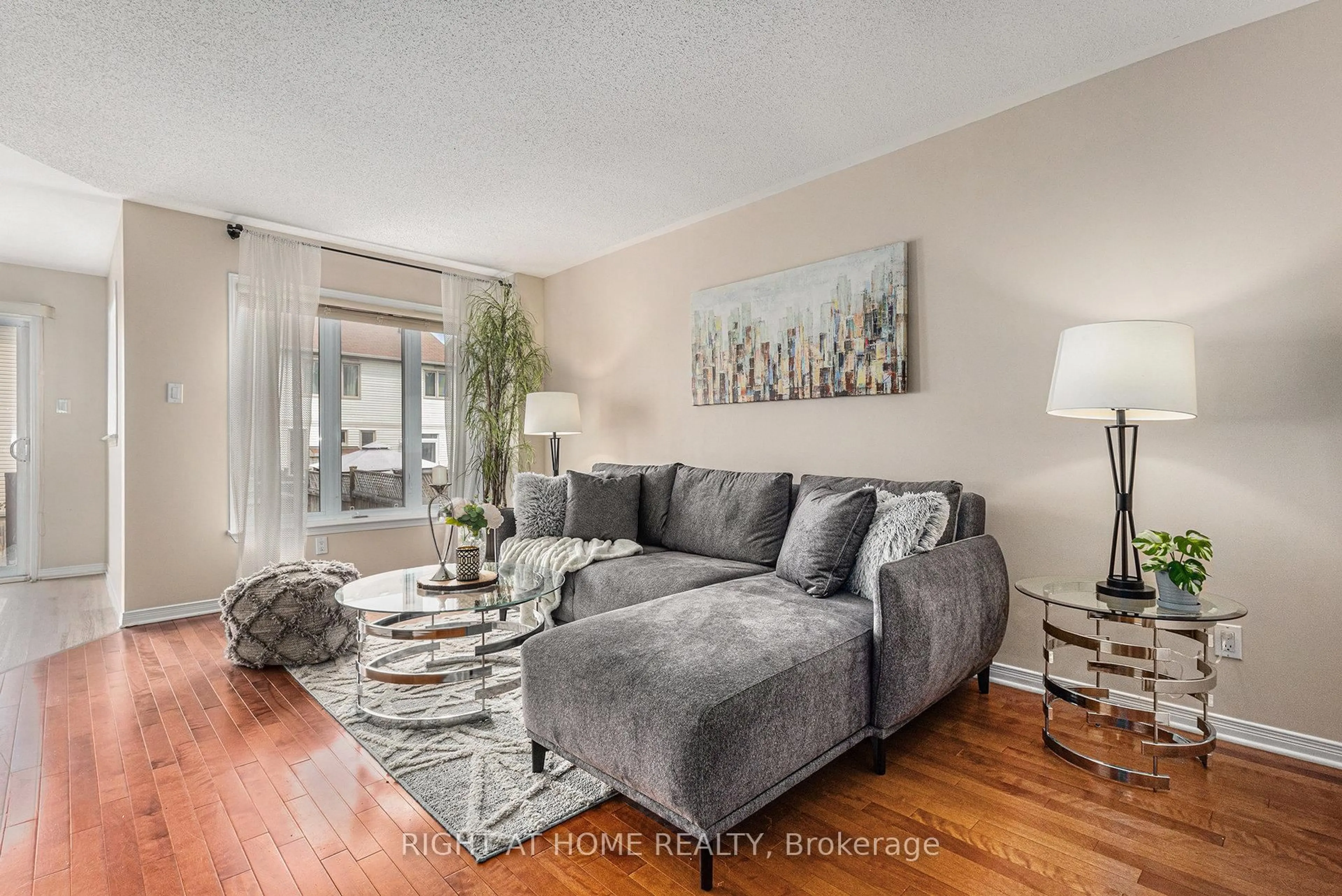 Living room with furniture, wood/laminate floor for 194 Deercroft Ave, Ottawa Ontario K2J 5J4