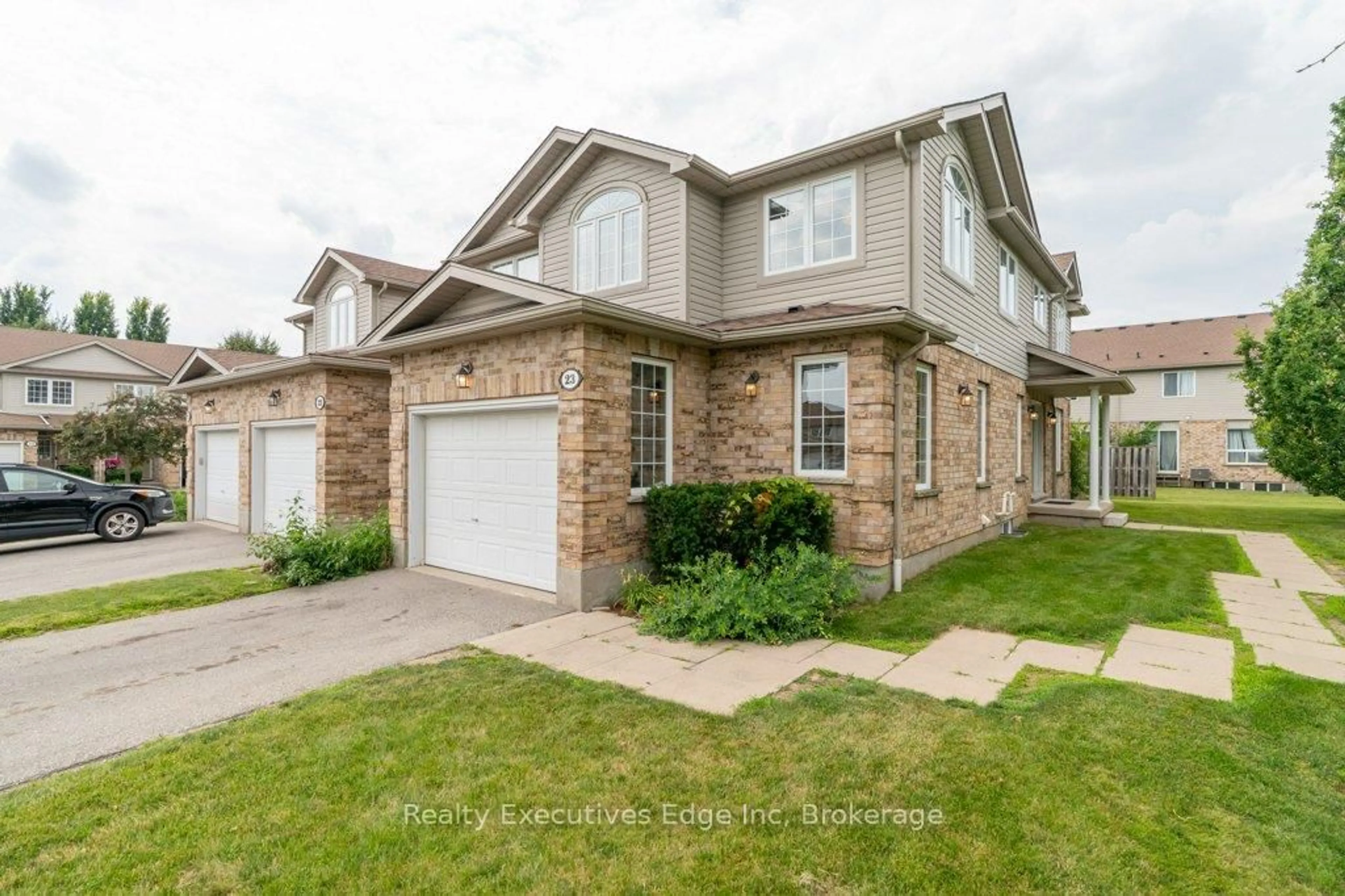 Home with brick exterior material, street for 210 Dawn Ave #23, Guelph Ontario N1G 5L5