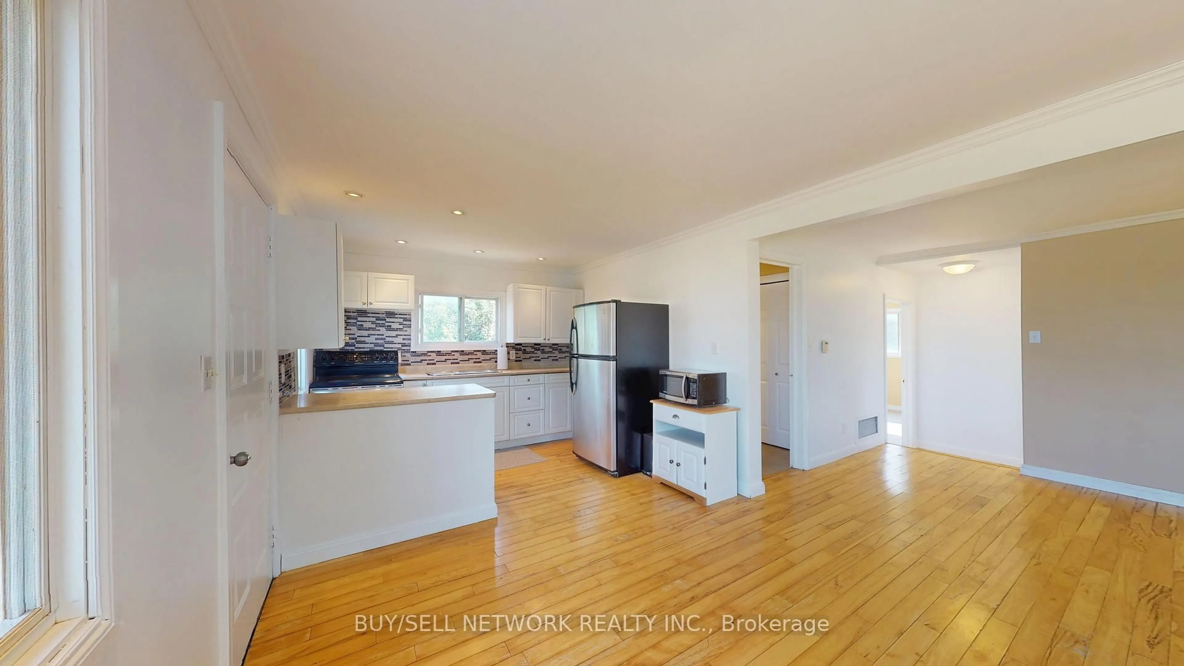 Open concept kitchen, wood/laminate floor for 879 Garthorne Ave, Selwyn Ontario K0L 1H0