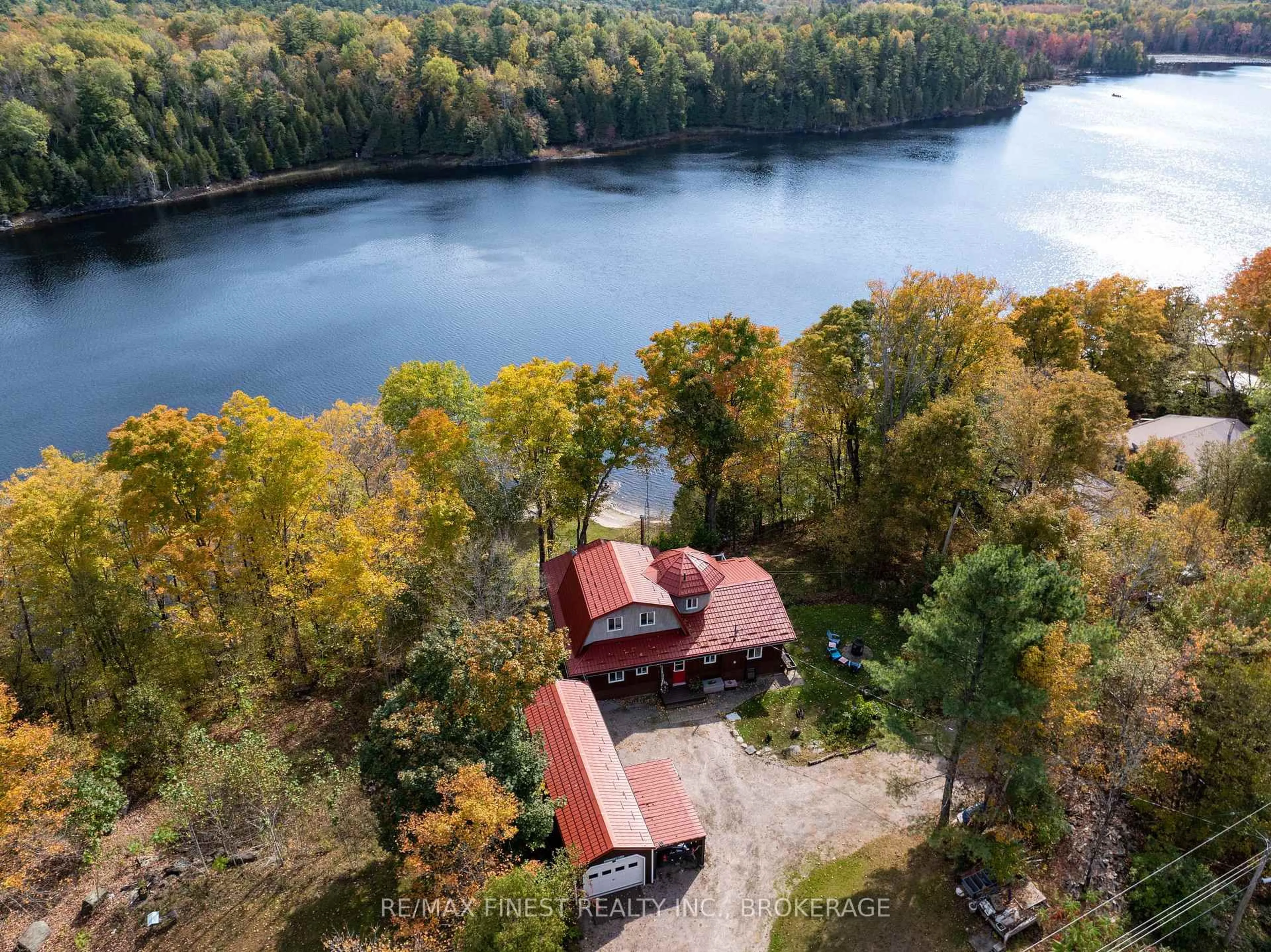 A pic from outside/outdoor area/front of a property/back of a property/a pic from drone, water/lake/river/ocean view for 1126 Fisherman Cove, Arden Ontario K0H 1B0