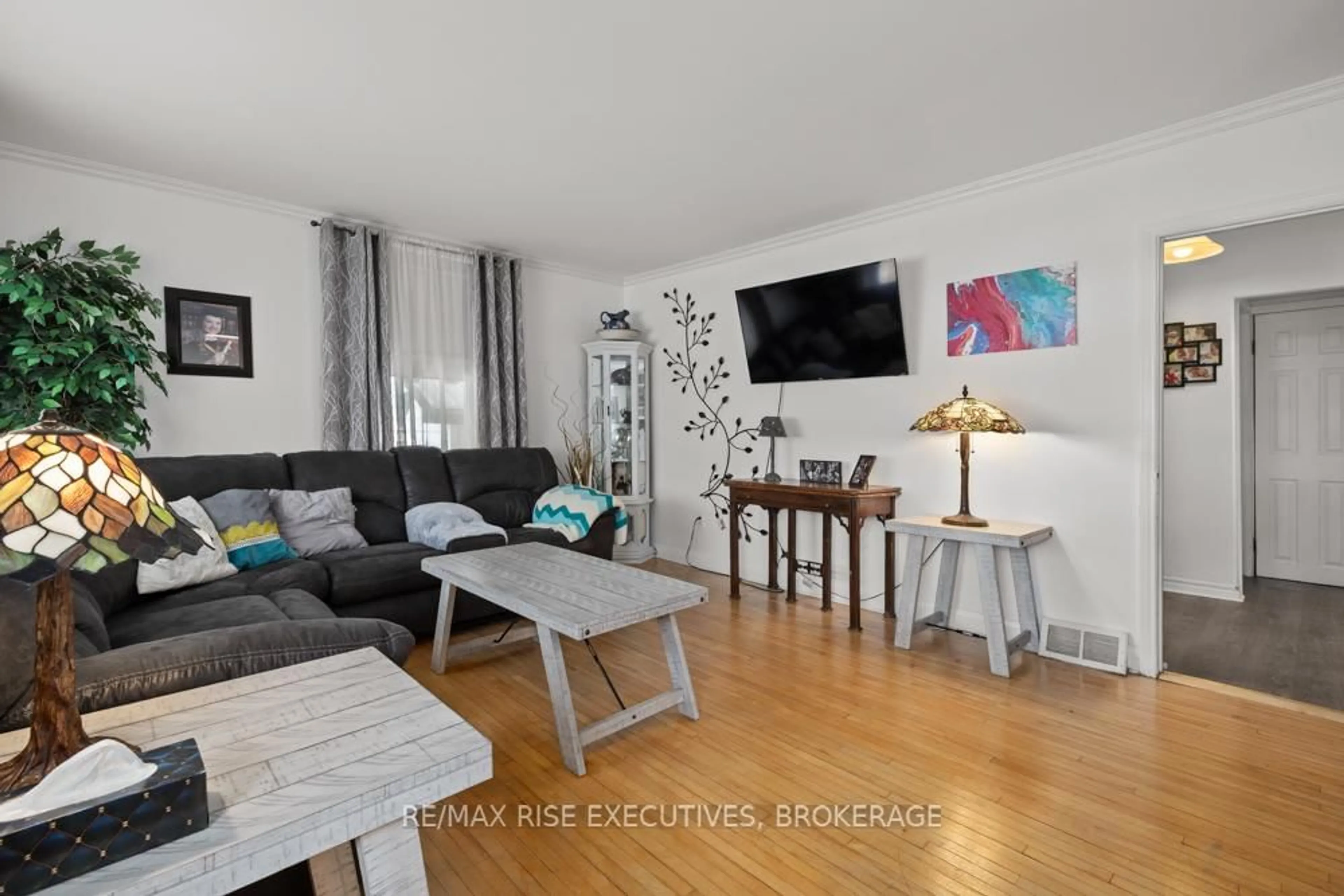 Living room with furniture, wood/laminate floor for 4699 Latimer Rd, Inverary Ontario K0H 1X0